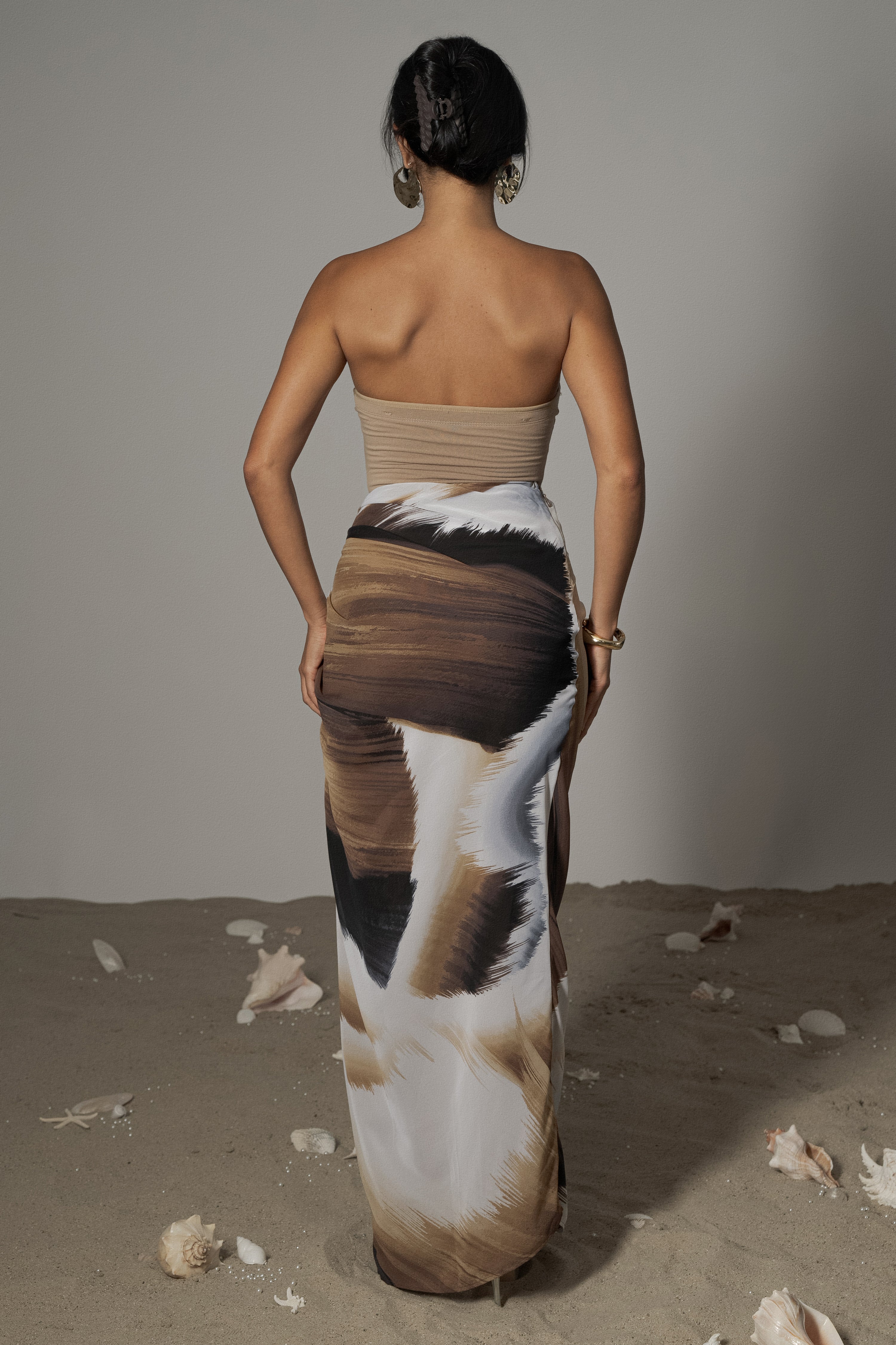 Brown abstract Noelia printed skirt by JLUXLABEL, showcasing its stylish design and flowy fabric.