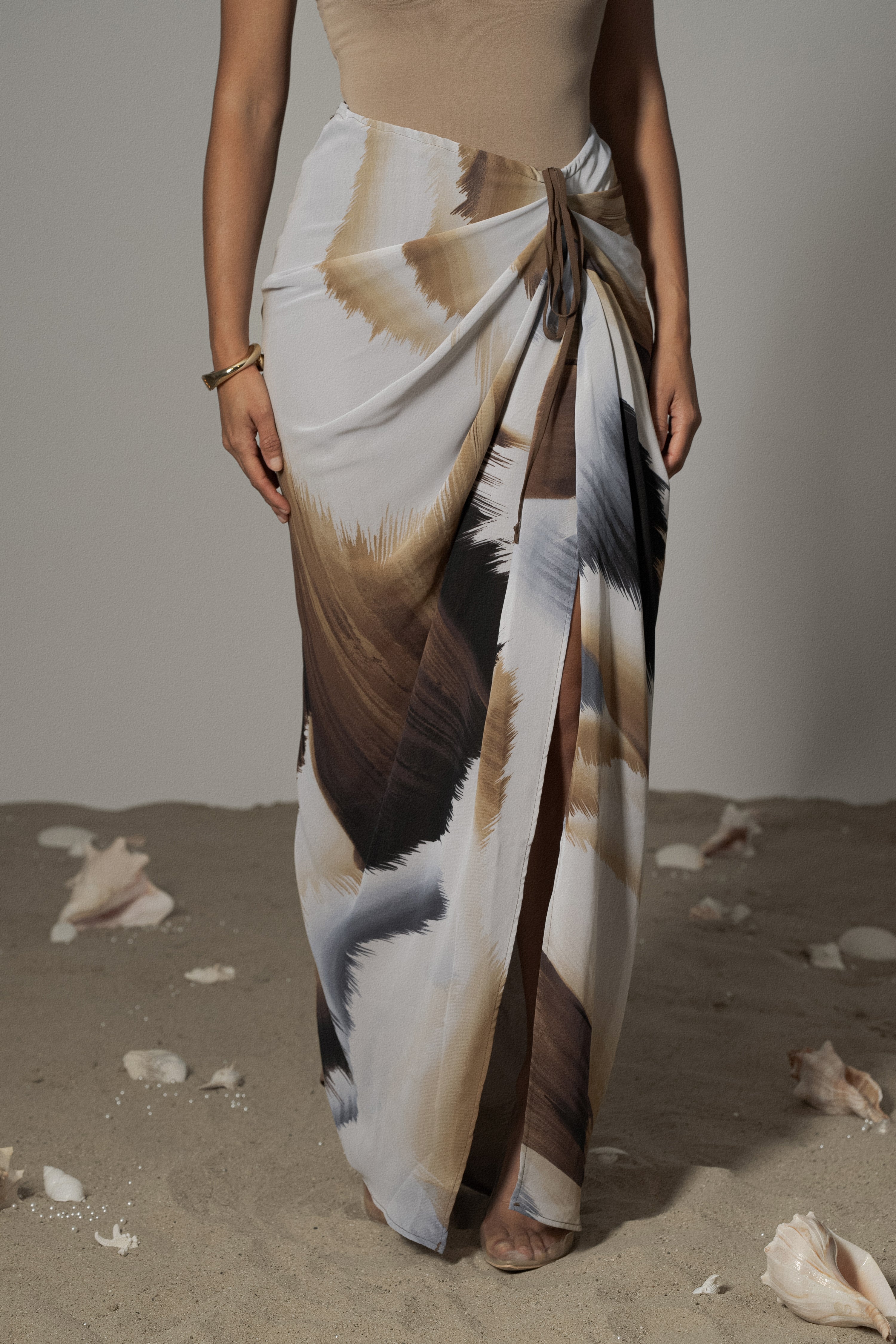 Brown abstract Noelia printed skirt by JLUXLABEL, featuring a stylish design and flowing fabric, perfect for casual or dressy occasions.