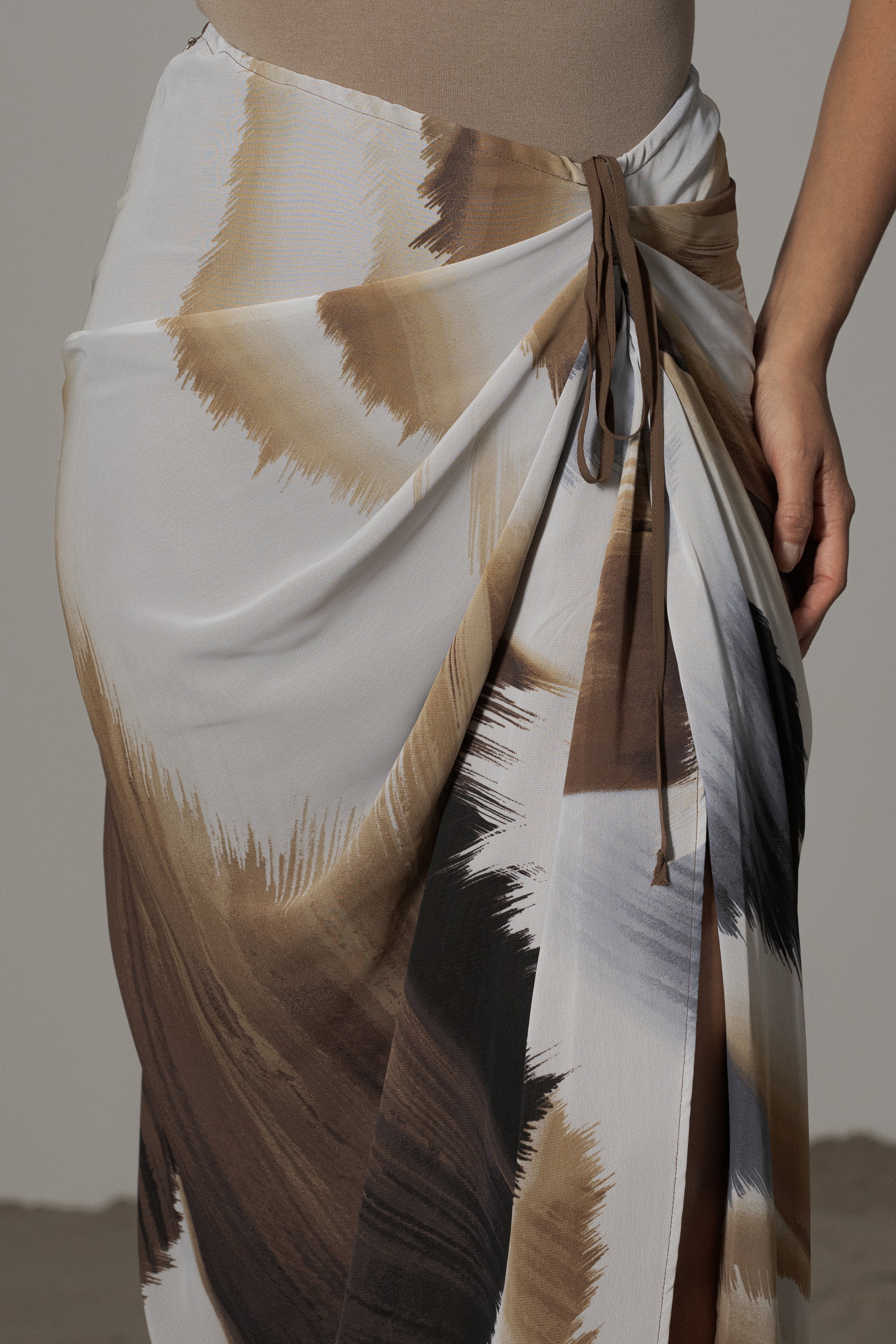 Brown abstract printed skirt from JLUXLABEL, stylish Noelia bottoms with a unique pattern and flowy fabric.