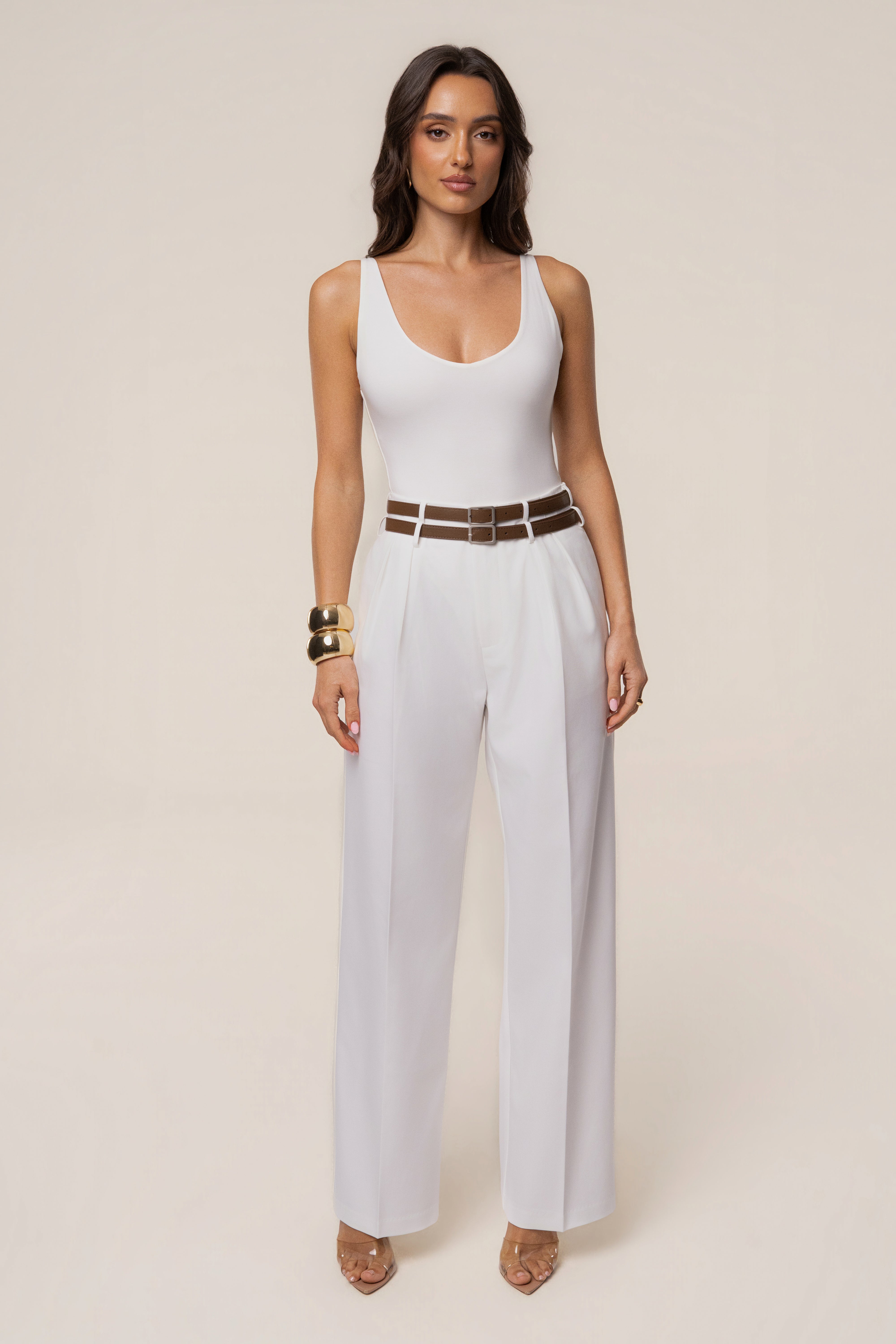 Ivory modern belted trousers from JLUXLABEL featuring a tailored fit and stylish design, shown on a model.