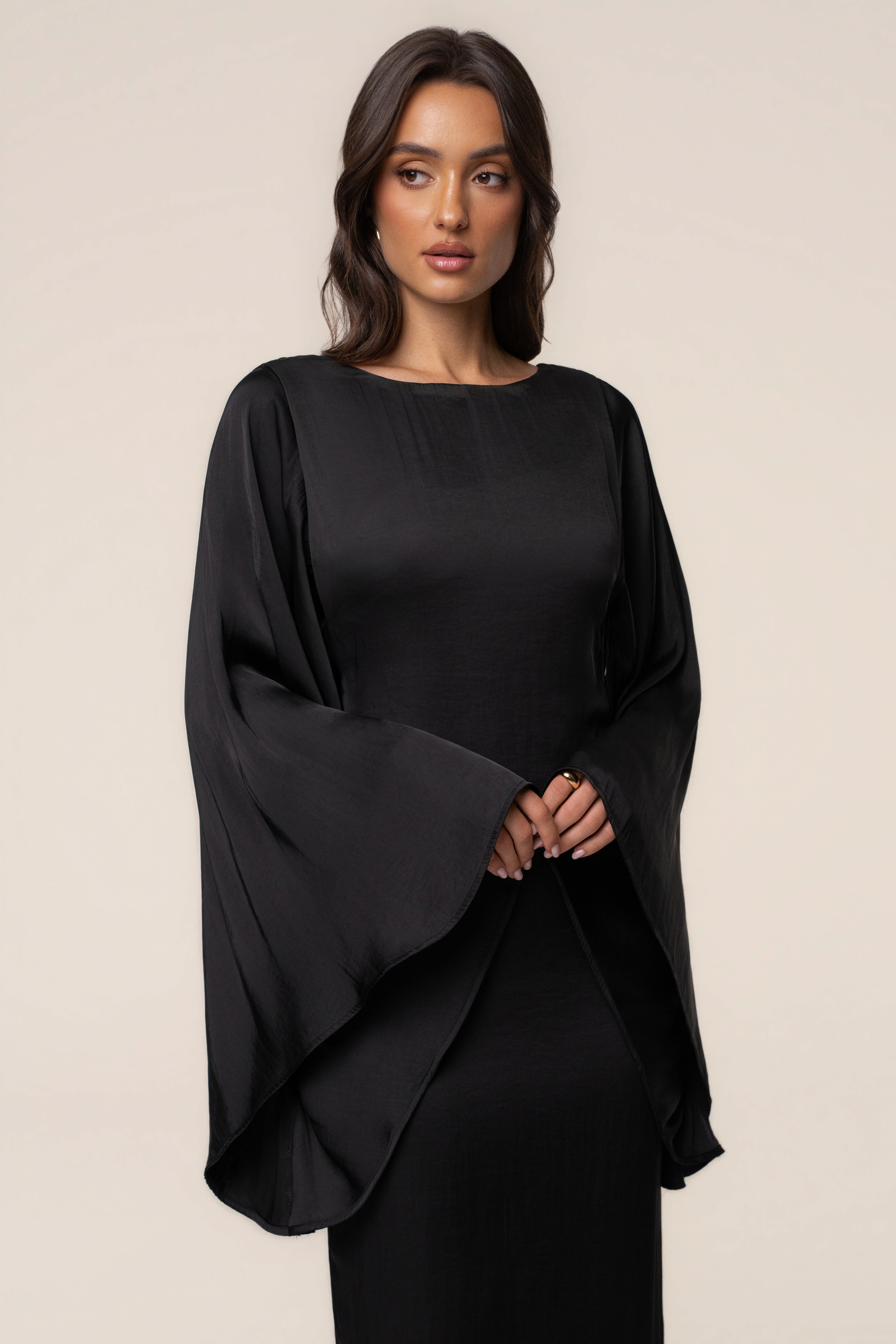 Black Soft Current Maxi Dress by JLUXLABEL, flowing fabric and elegant design, shown on a dress form.