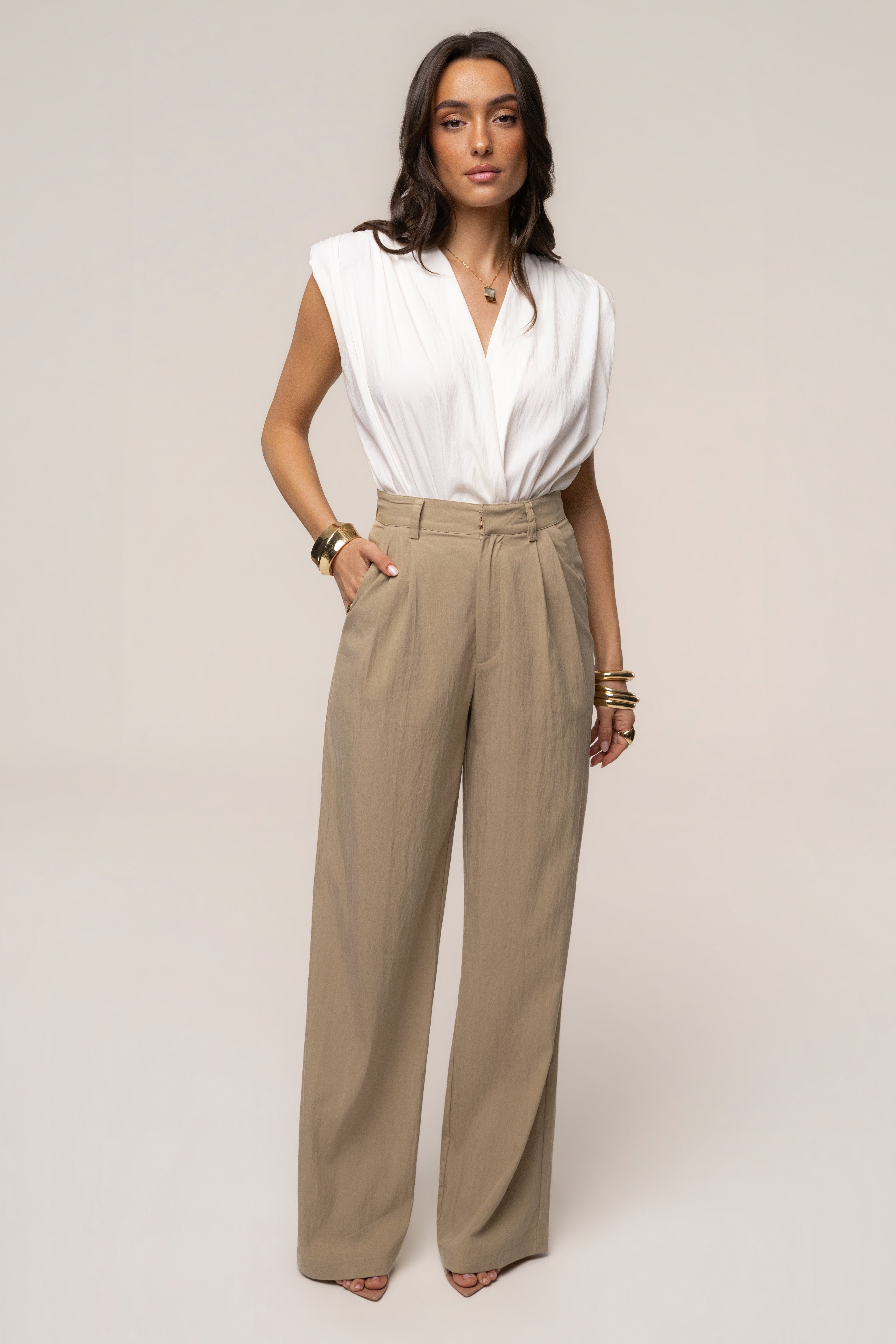 Ivory solar drift bodysuit by JLUXLABEL, featuring a stylish sleeveless top with a fitted design and scoop neckline.