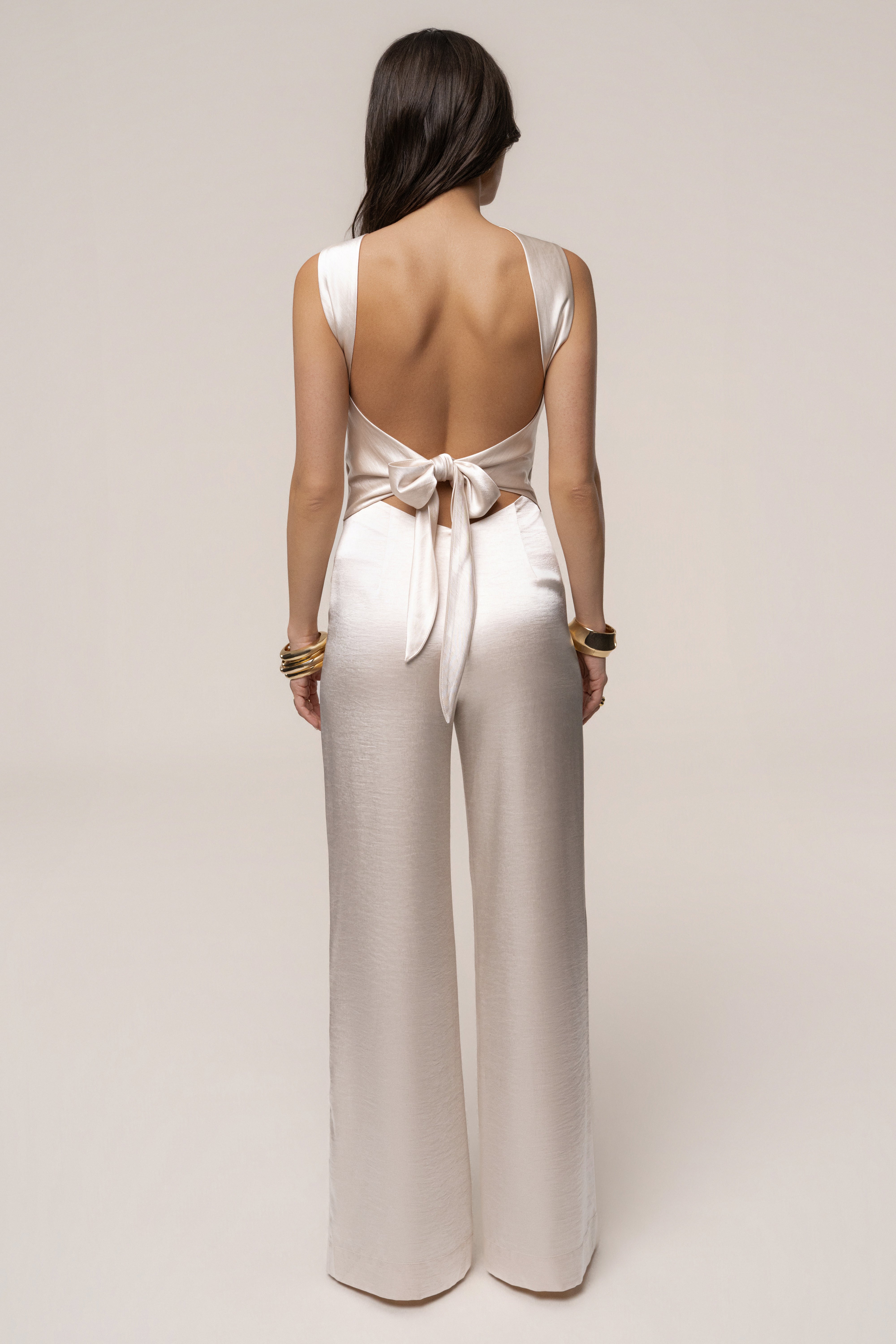 Ivory Premiere one-shoulder jumpsuit from JLUXLABEL, featuring a stylish design with a single shoulder strap and tailored fit.