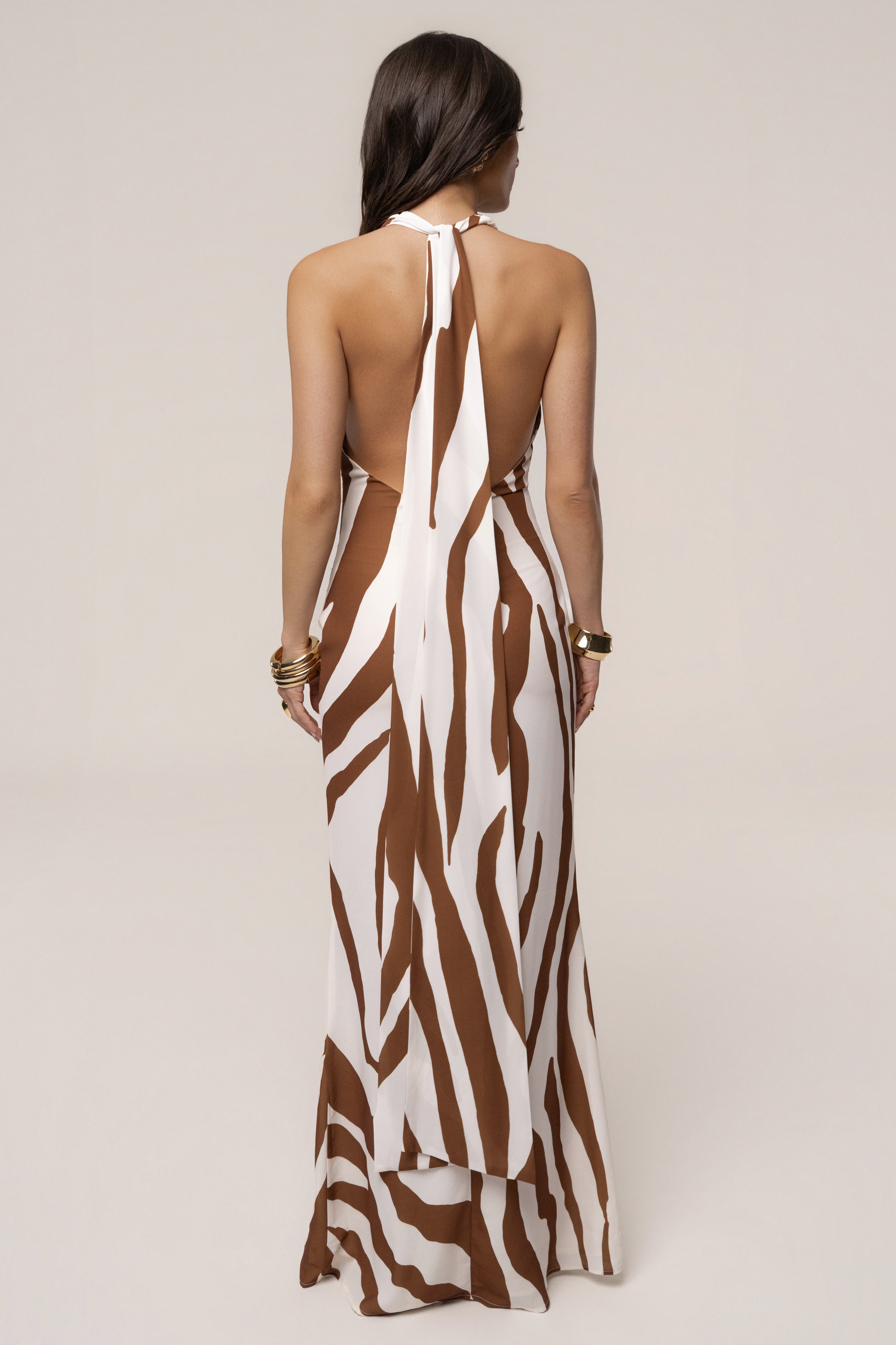 Brown Zebra Impressions plunge maxi dress by JLUXLABEL, featuring a flowing fabric and bold zebra print design.