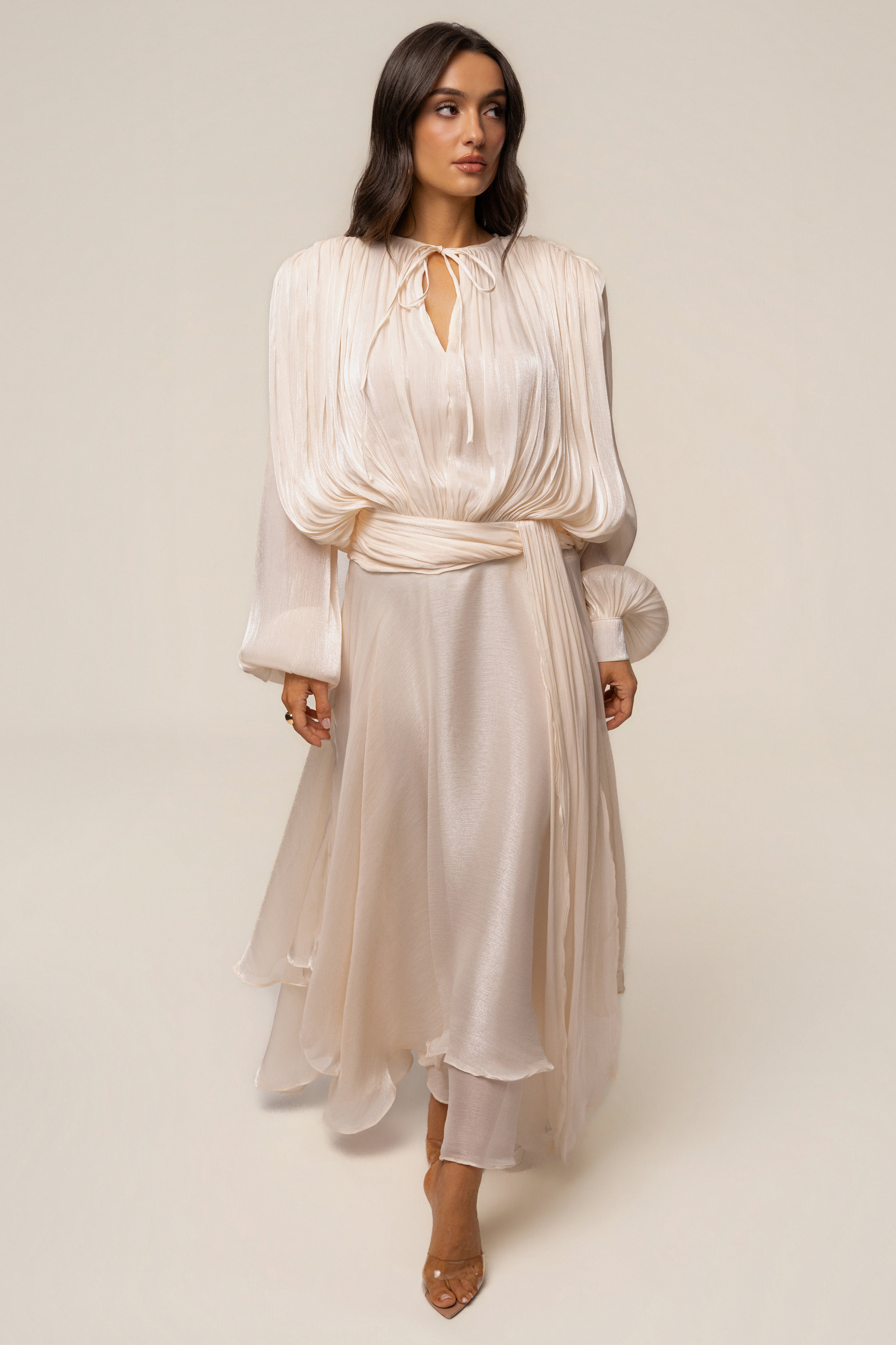 Cream draped maxi dress by JLUXLABEL featuring elegant flowing fabric and a sophisticated silhouette.