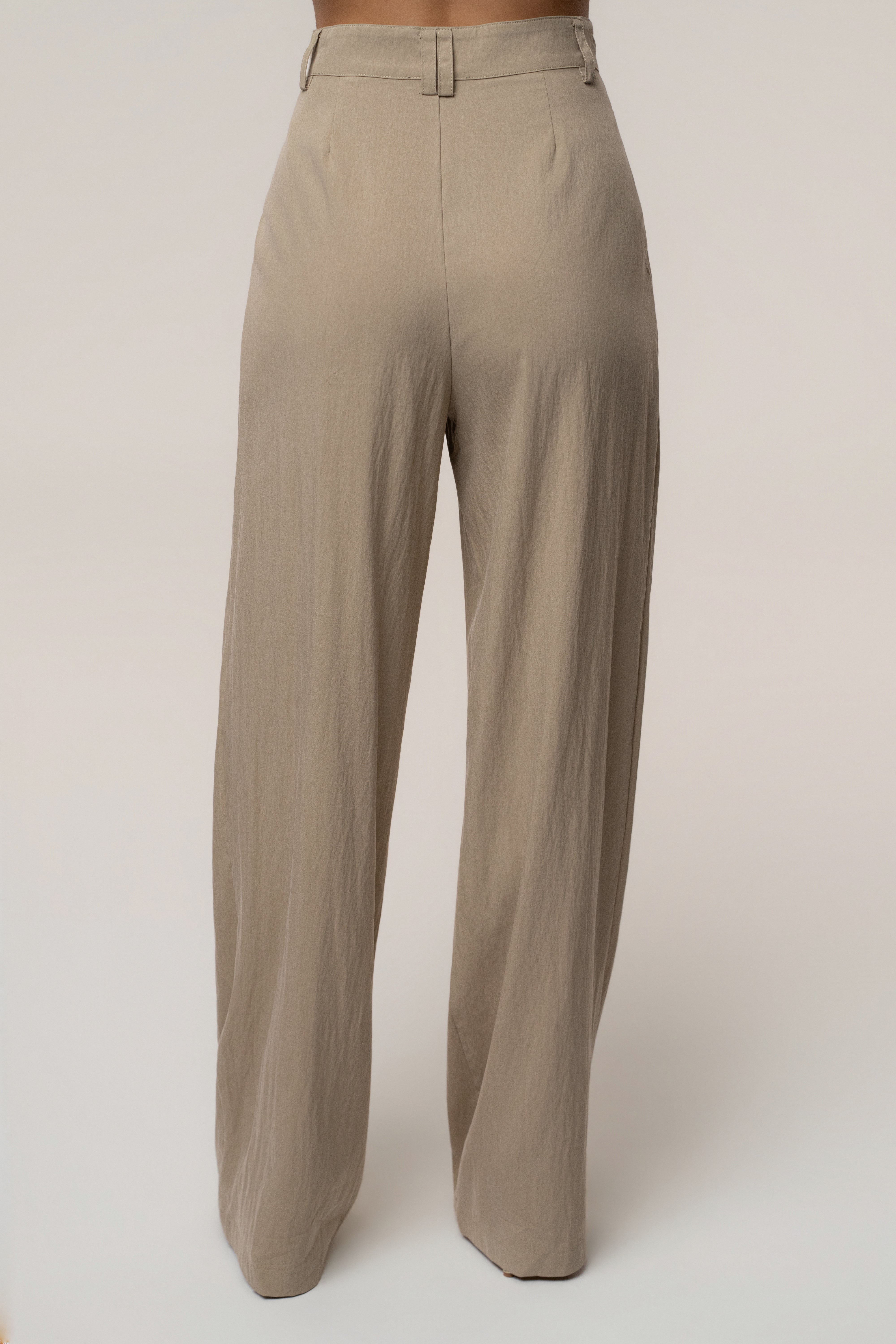 Taupe JLUXLABEL essential flow trousers, stylish bottoms with a relaxed fit and versatile design, shown on a model.