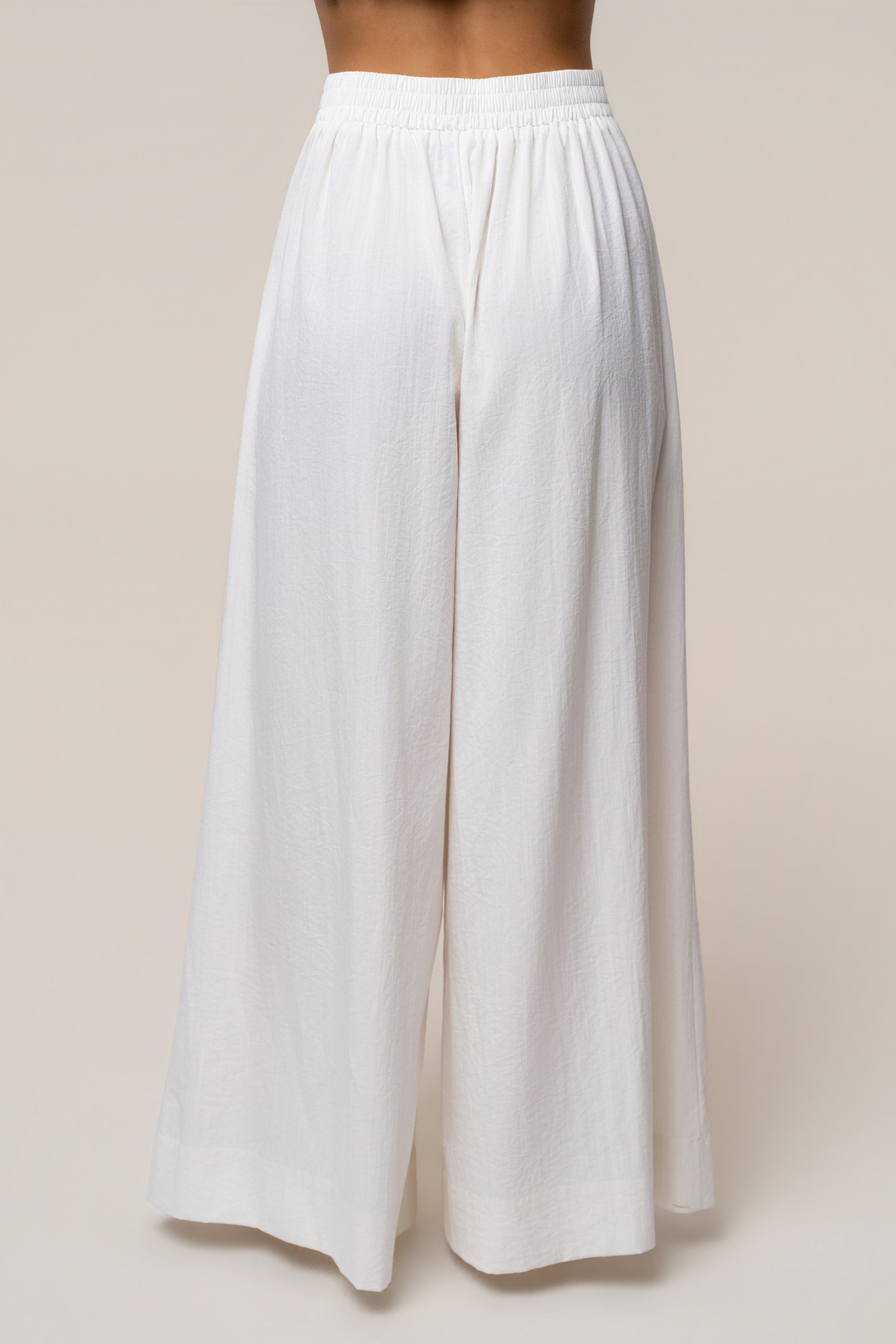 Back waist view of ivory Sunset Breeze Pant Set featuring an elastic waistband and flowing wide-leg pants