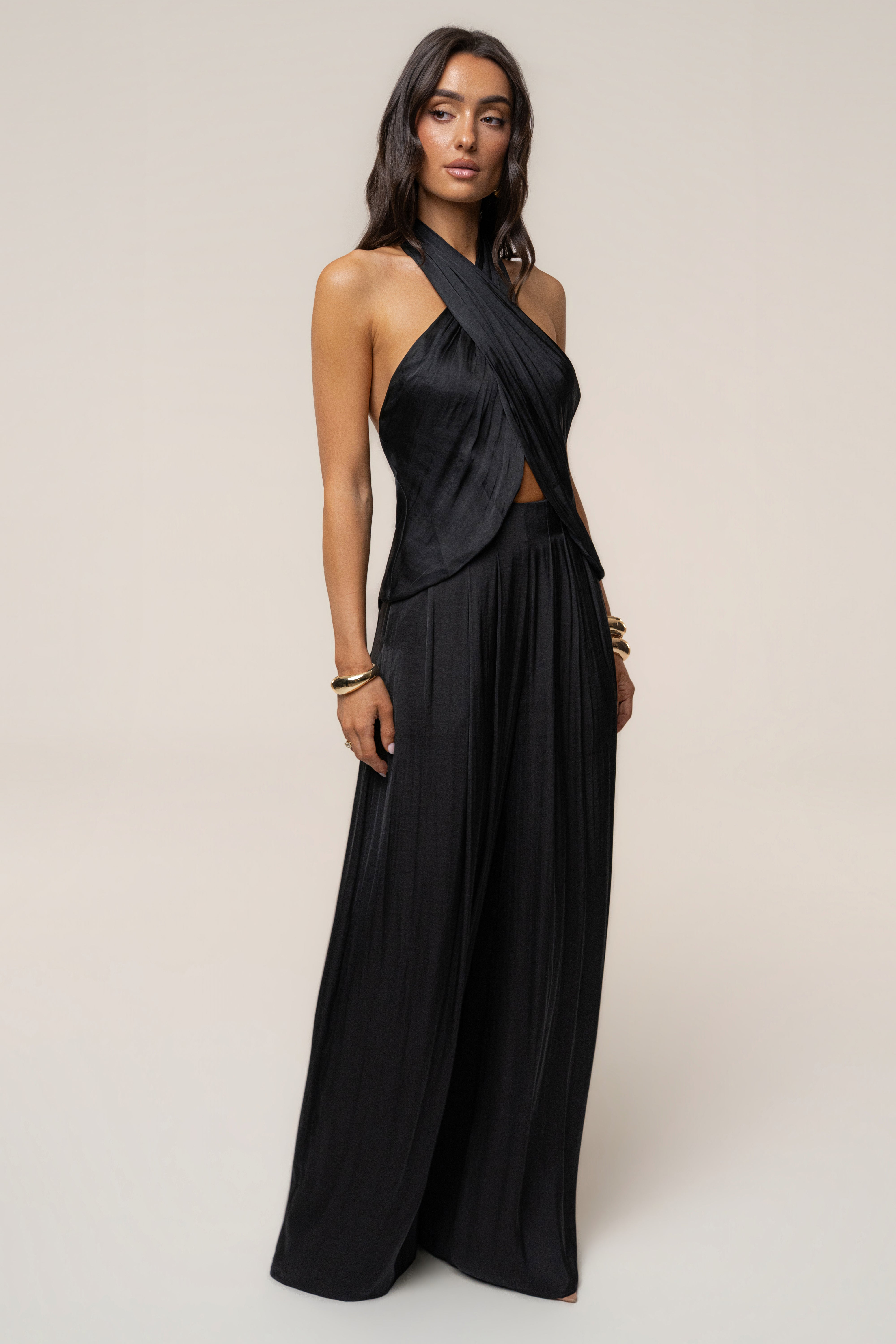 Black cross wrap halter top with front twist and exposed midriff