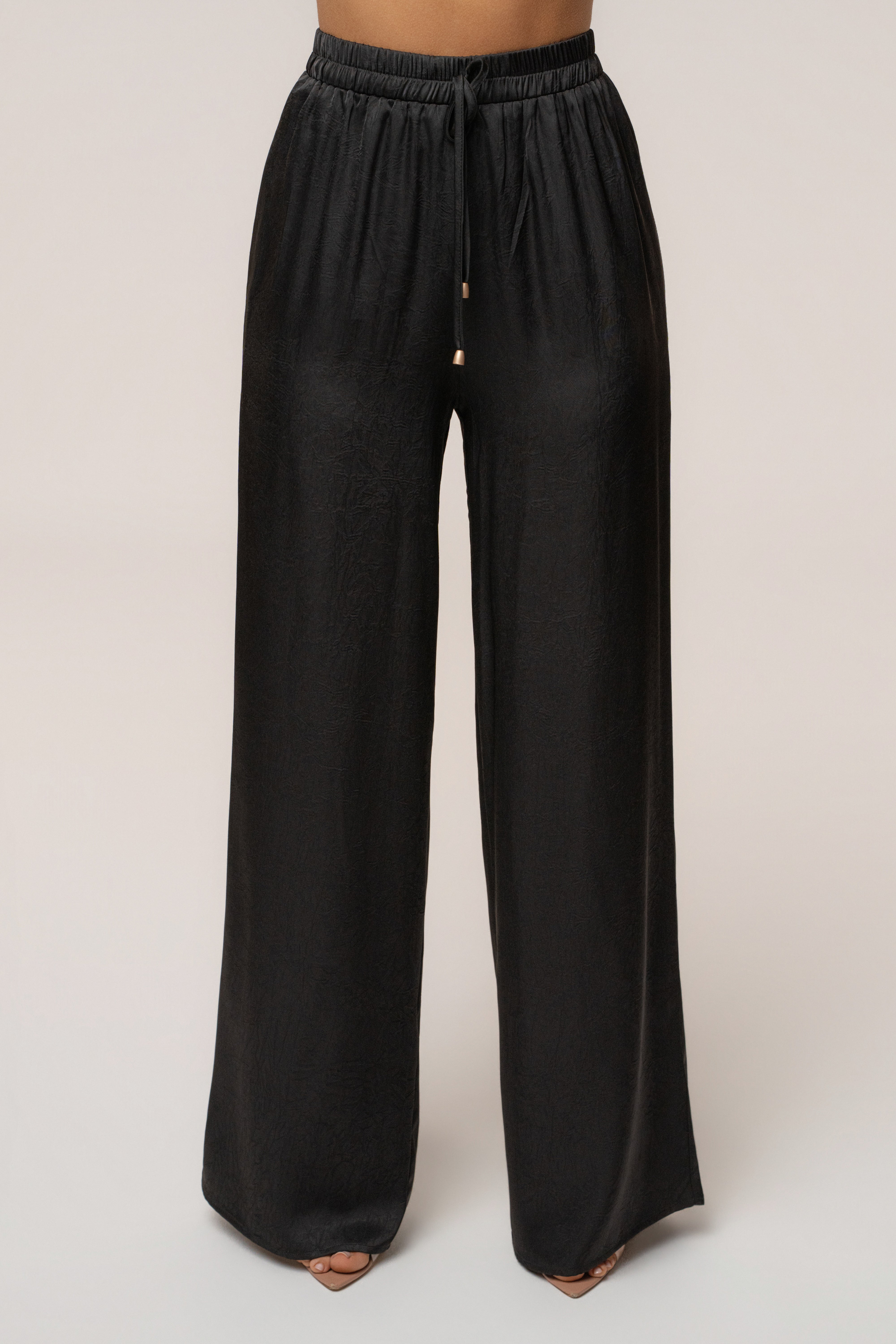 Black satin pant set with draped design by JLUXLABEL, featuring a stylish and elegant matching top and pants ensemble.