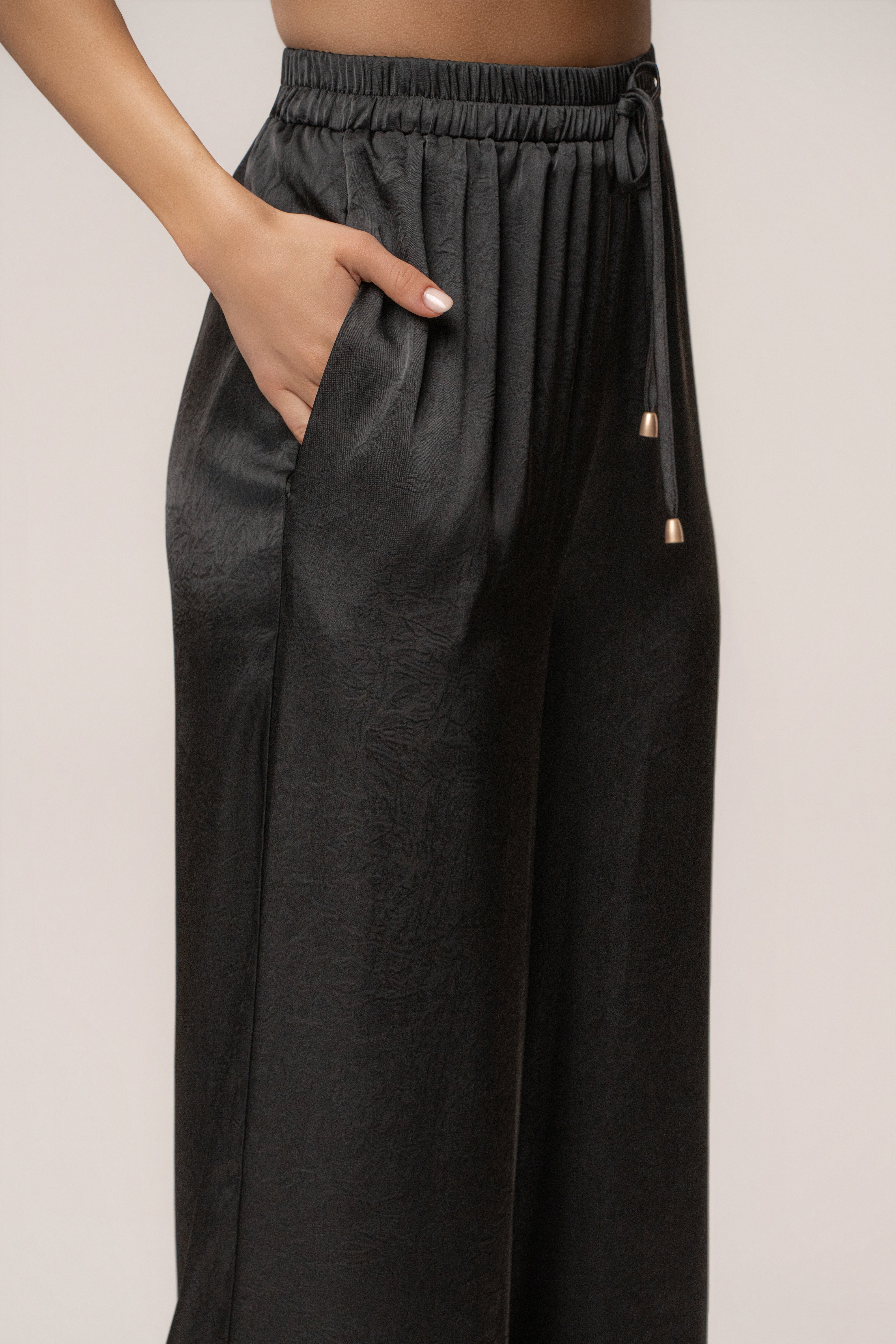 Black draped satin pant set by JLUXLABEL featuring a stylish, flowing design and matching high-waisted pants.