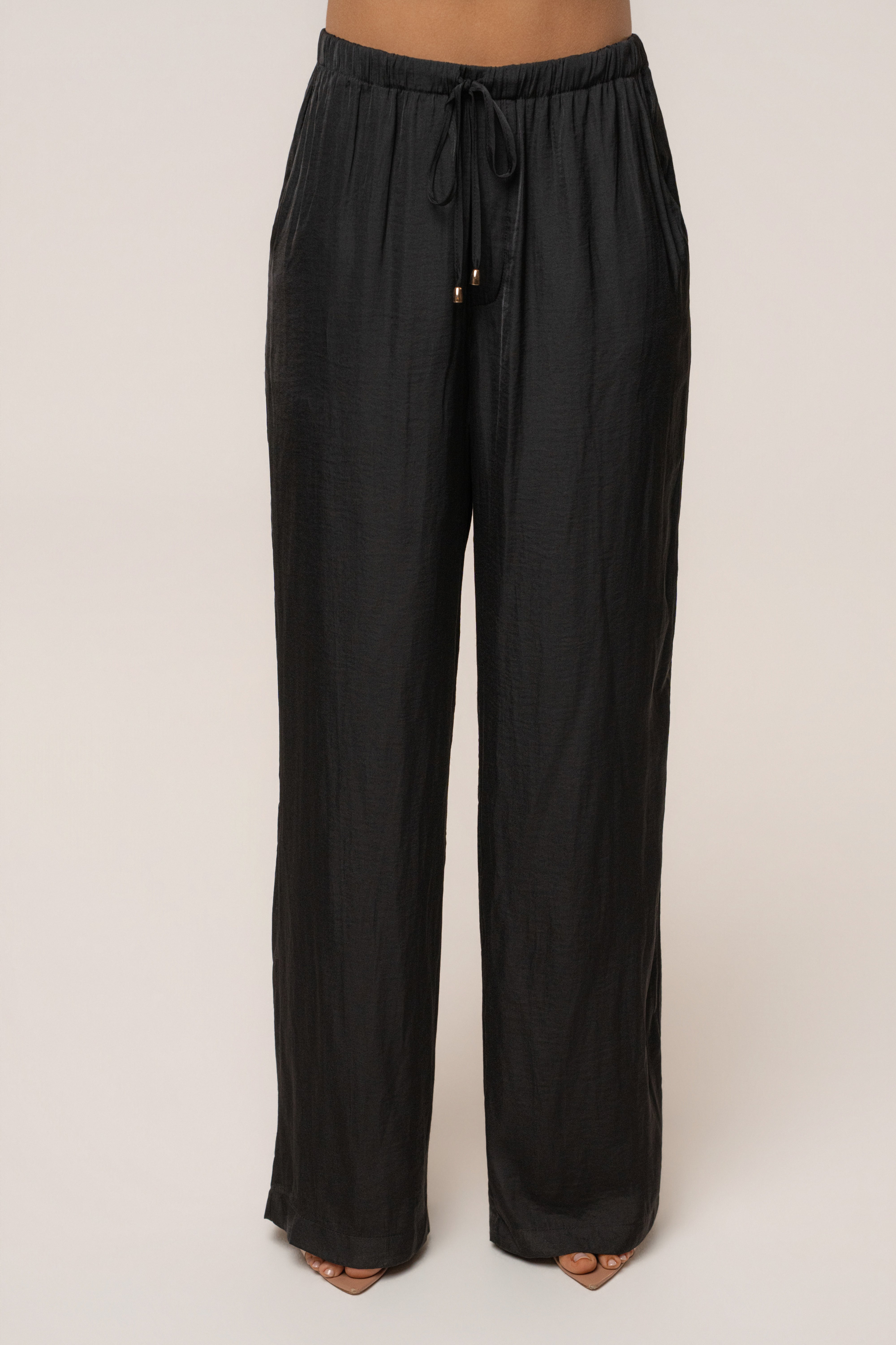 Black Seaside Glow pants by JLUXLABEL, stylish bottoms with a relaxed fit and glowing seaside-inspired design.