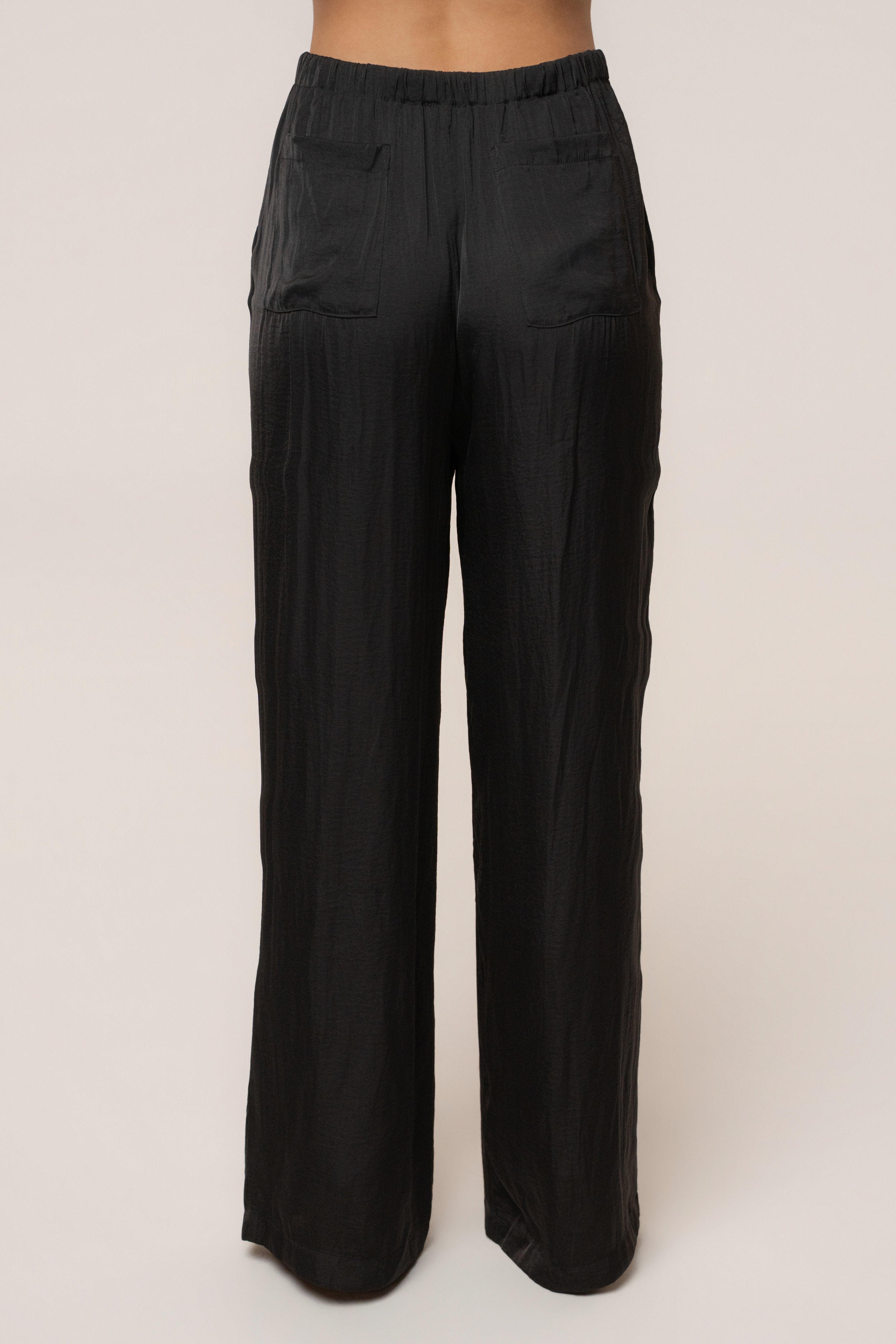Black Seaside Glow Pants by JLUXLABEL, stylish bottoms featuring a sleek design with glow details, perfect for casual or beachwear.