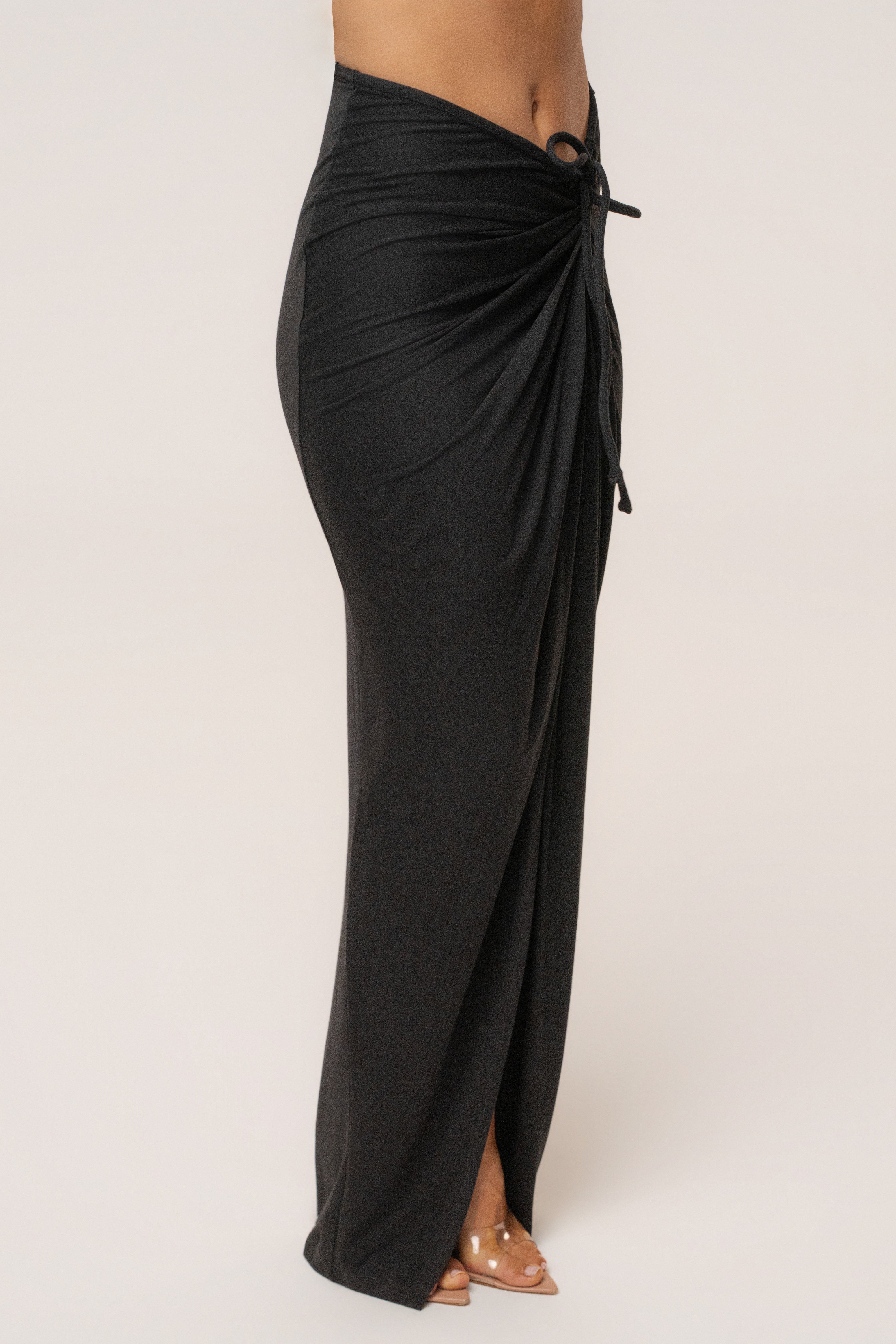 Black Island Drape Maxi Skirt by JLUXLABEL, flowing black maxi skirt with draped design, styled as a stylish bottoms piece.