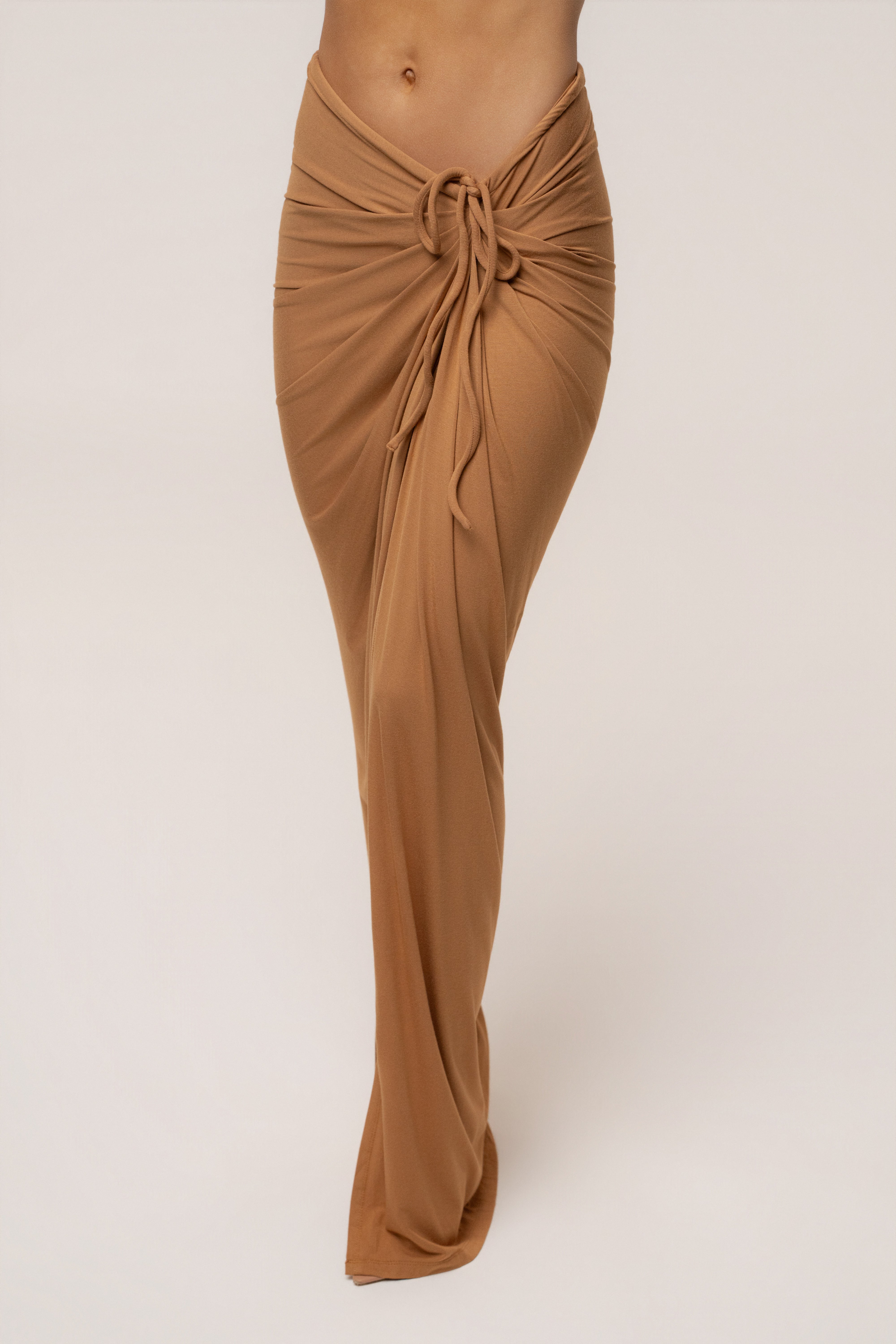 Tan JLUXLABEL Island Drape Maxi Skirt with flowing fabric and high waist, styled as a stylish boho bottoms piece.