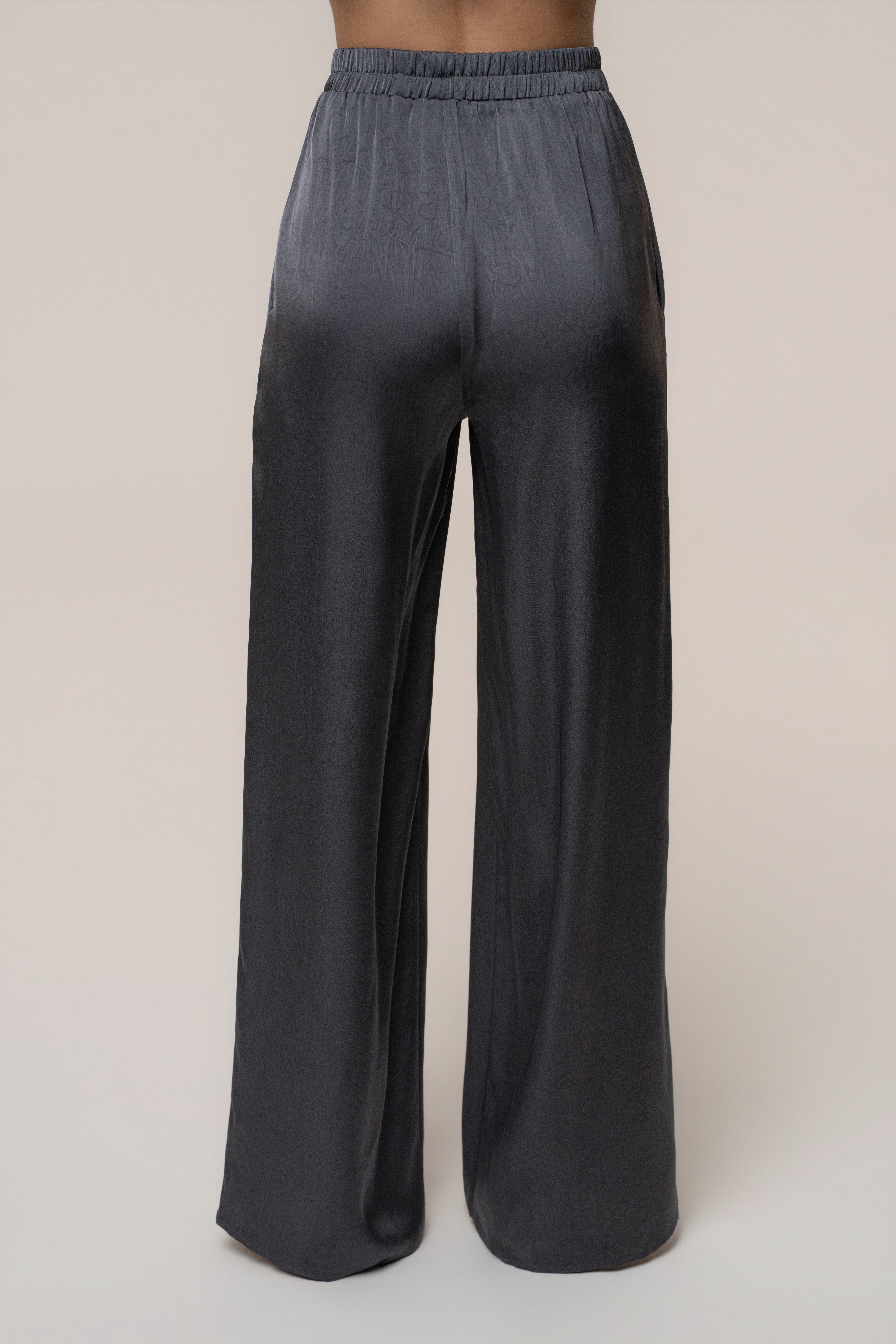 Midnight blue satin pant set with draped design by JLUXLABEL, featuring elegant, flowing fabric and stylish, relaxed fit.