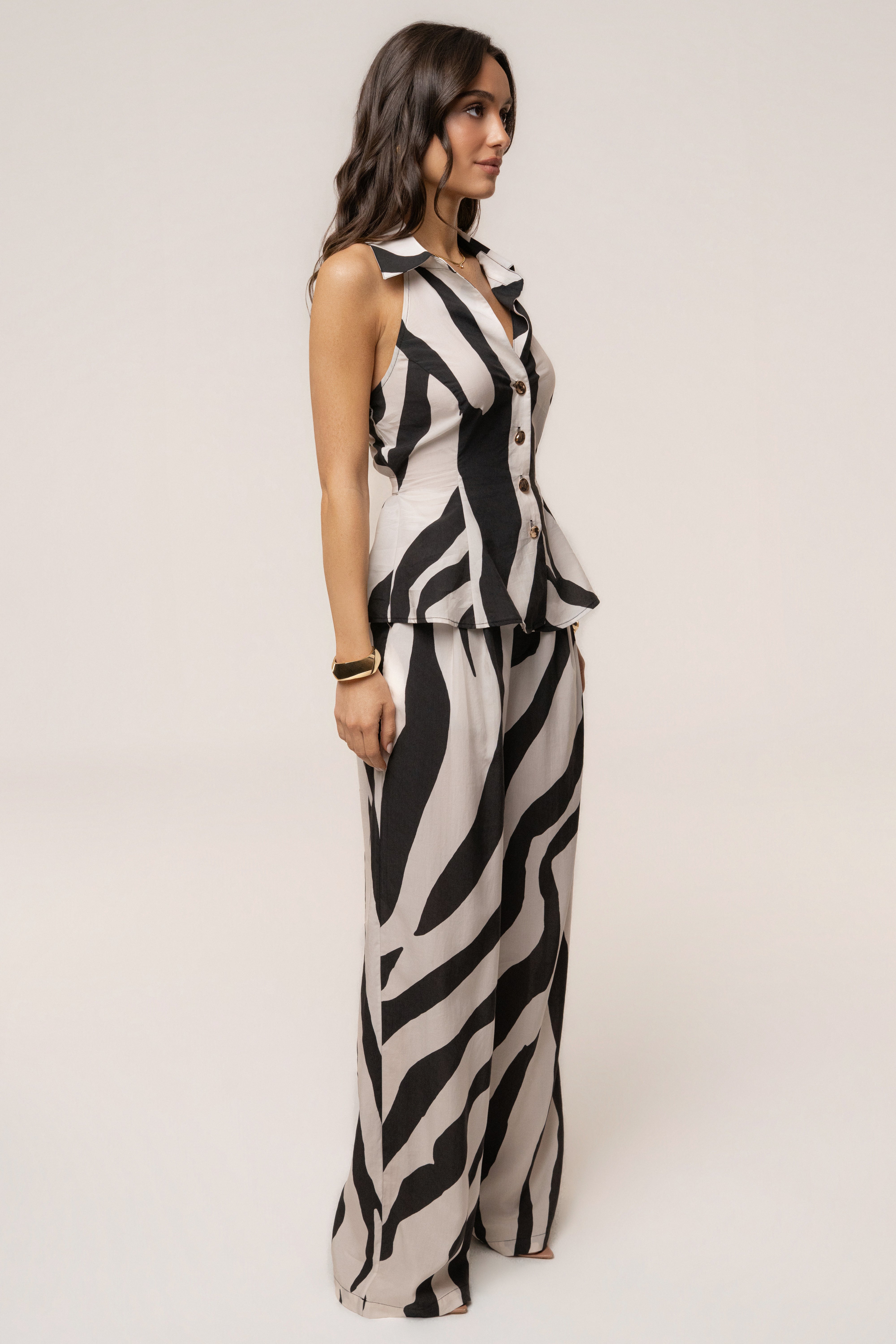 Zebra print tailored halter top by JLUXLABEL featuring a fitted design and high neckline, displayed on a mannequin.