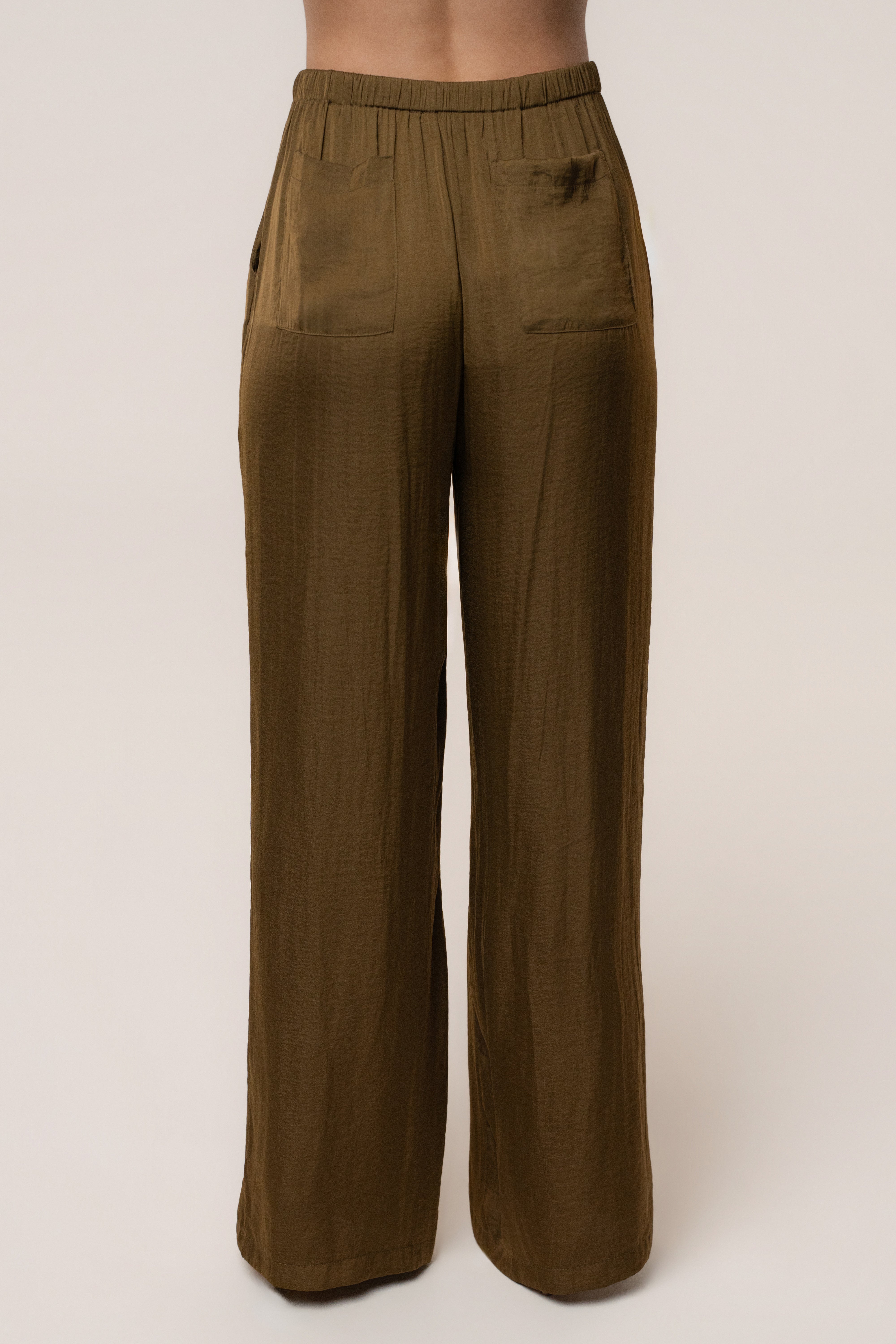JLUXLABEL Olive Seaside Glow Pants, stylish bottoms with a relaxed fit, showcased on a model in a casual outdoor setting.