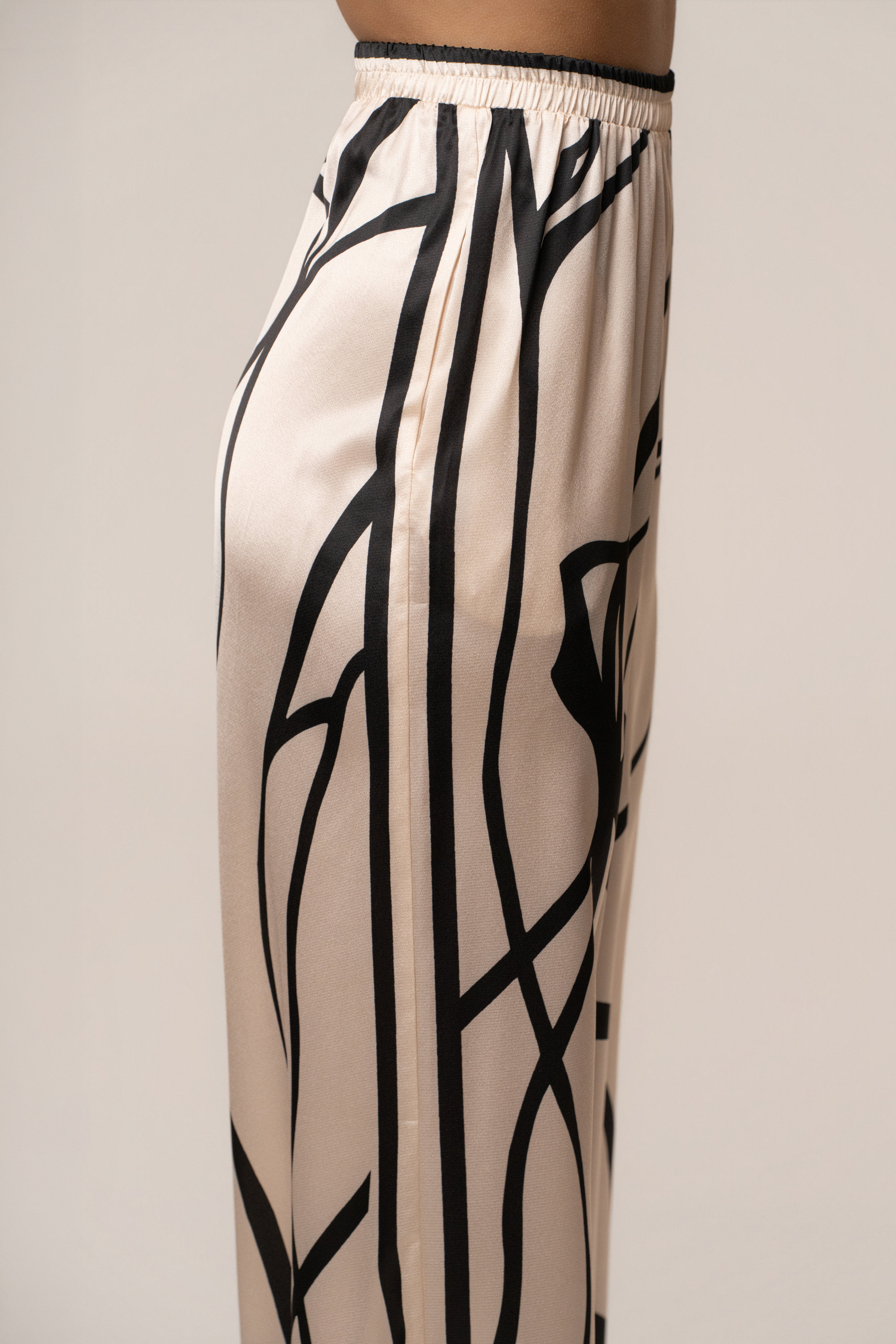 Cream and black Art Form pant set by JLUXLABEL featuring stylish, comfortable matching top and pants ensemble.