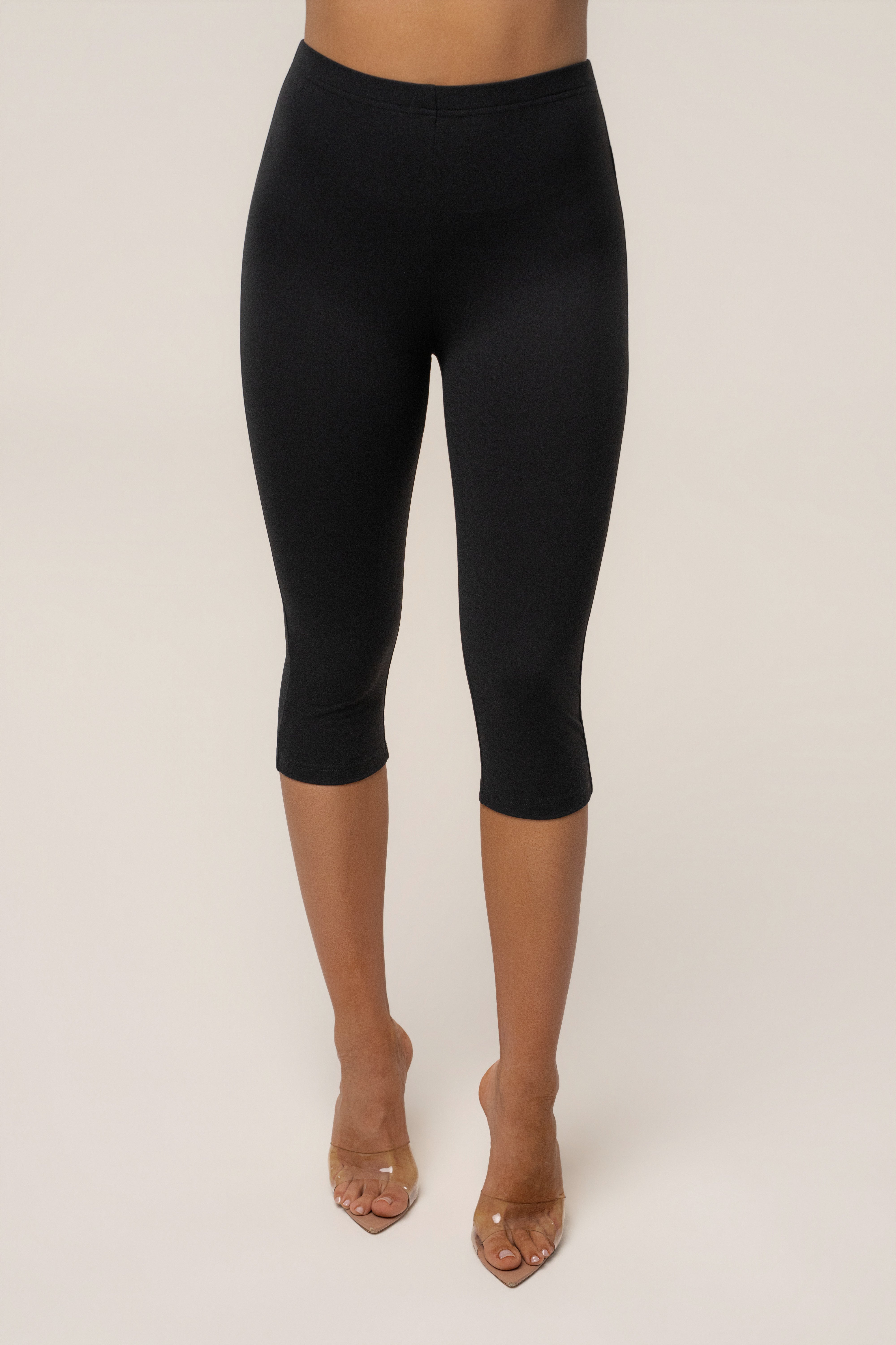 Black JLUXLABEL essential Capri leggings shown as stylish, stretchy bottoms perfect for active or casual wear.