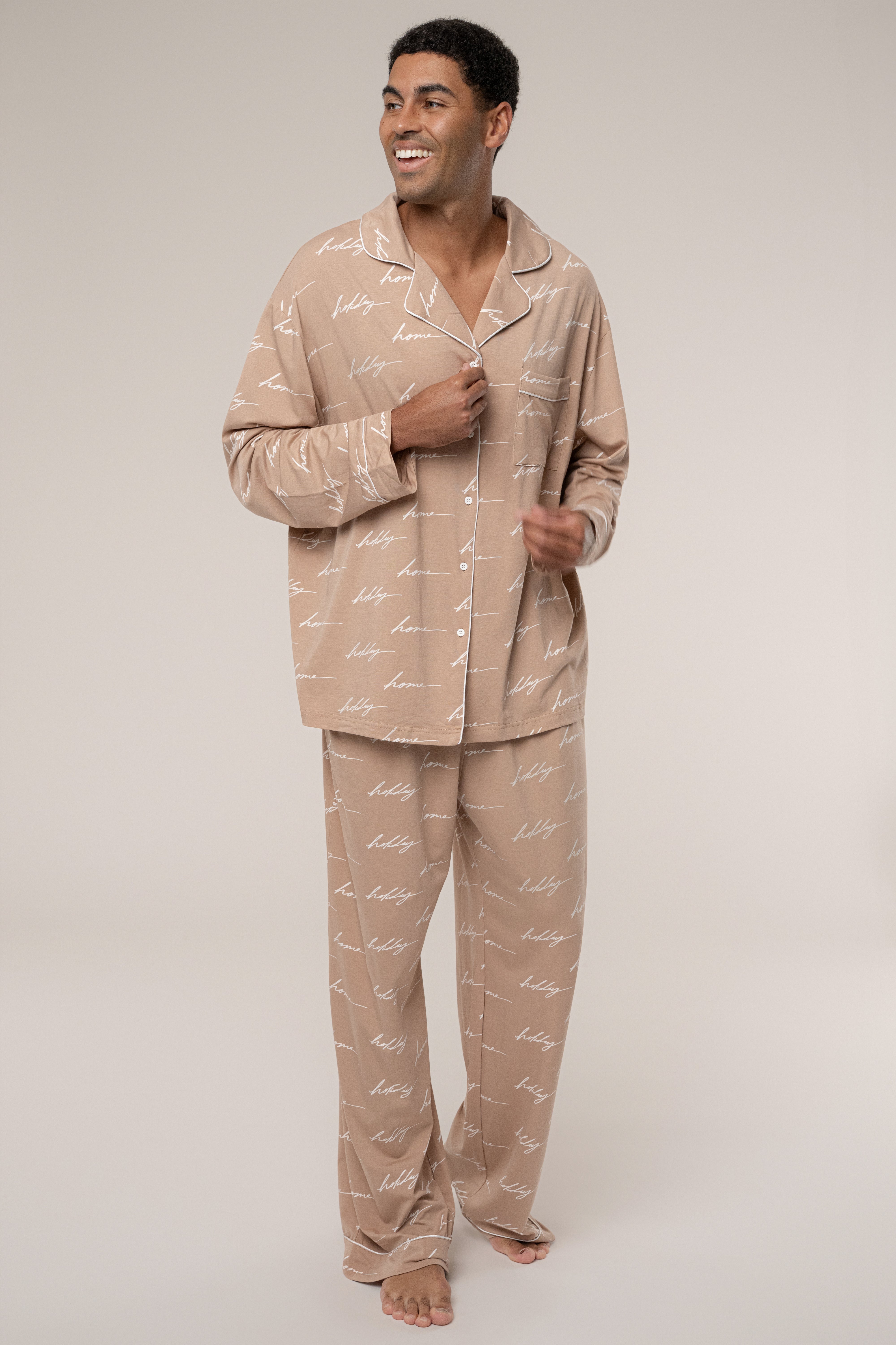 Man wearing beige pajamas with a pattern on a plain background