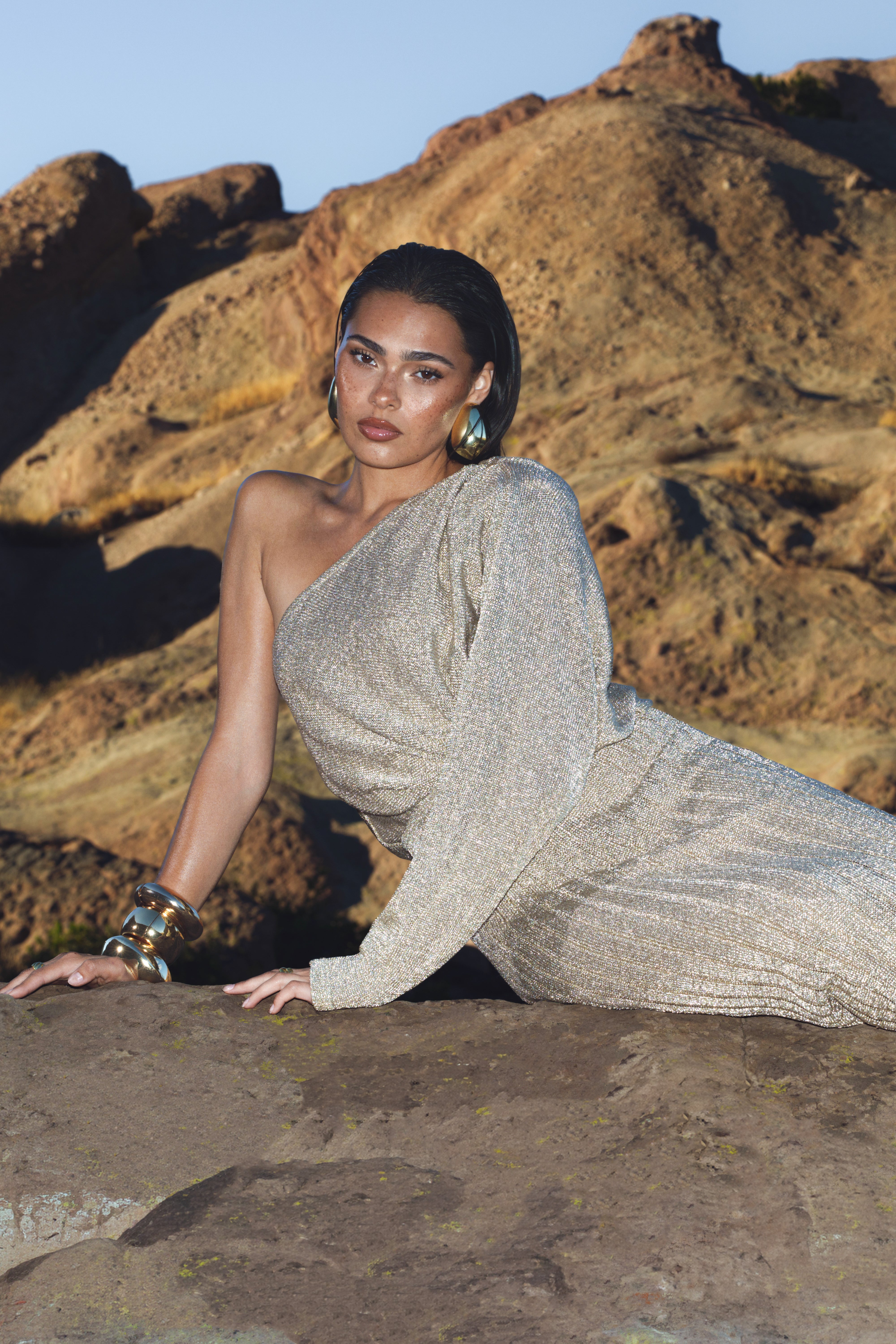 Gold metallic bodysuit from JLUXLABEL's resort collection, featuring a shiny, fitted top with sleek design details.