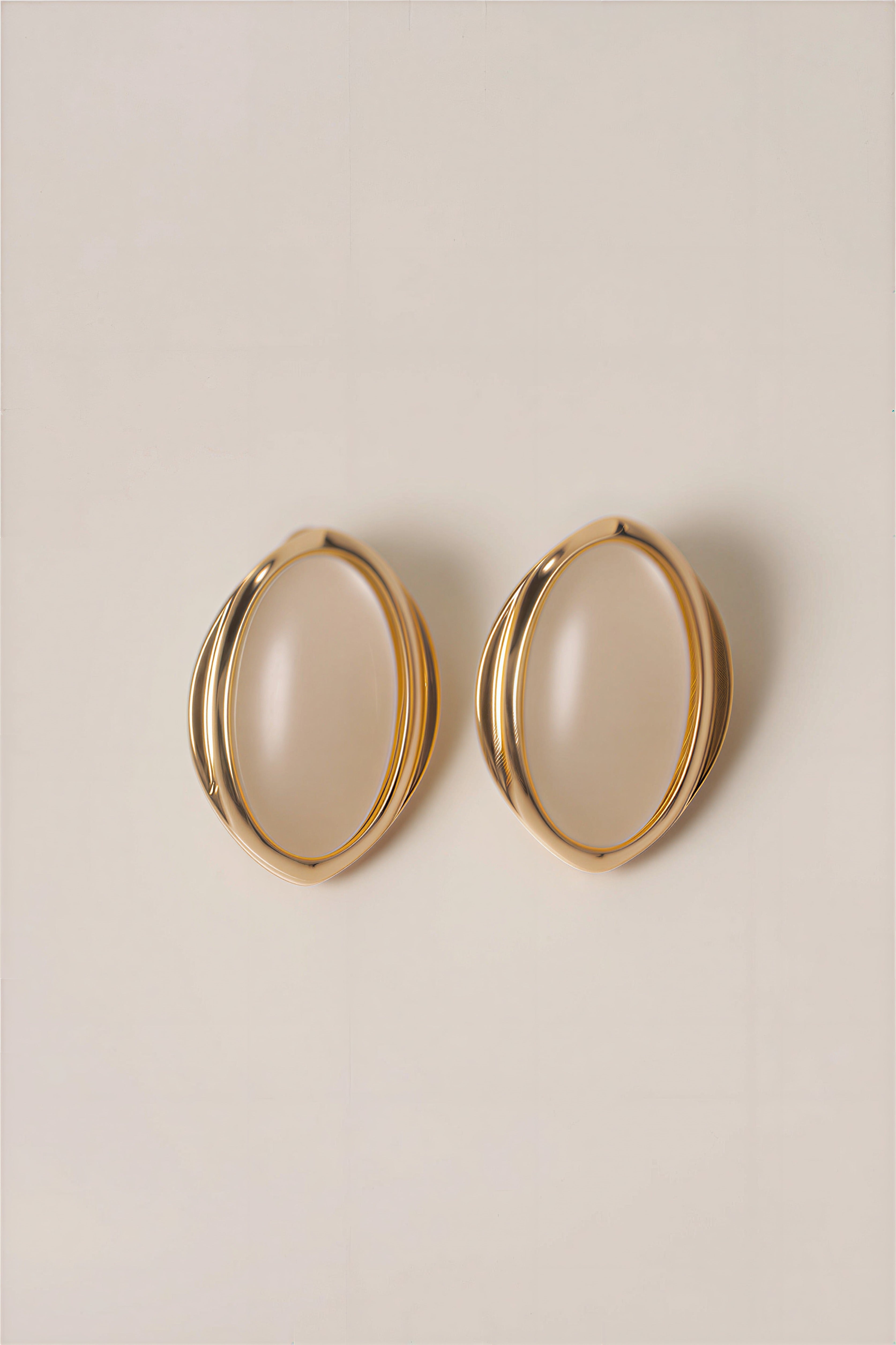 Pair of large gold tone oval hoop earrings with layered rounded frames