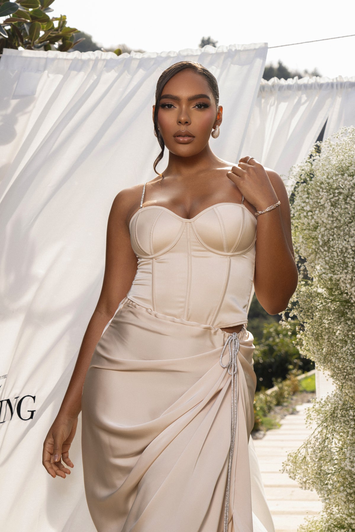 JLUXLABEL Champagne Leo Matte Satin Bustier top with structured design and satin finish, shown on a model.