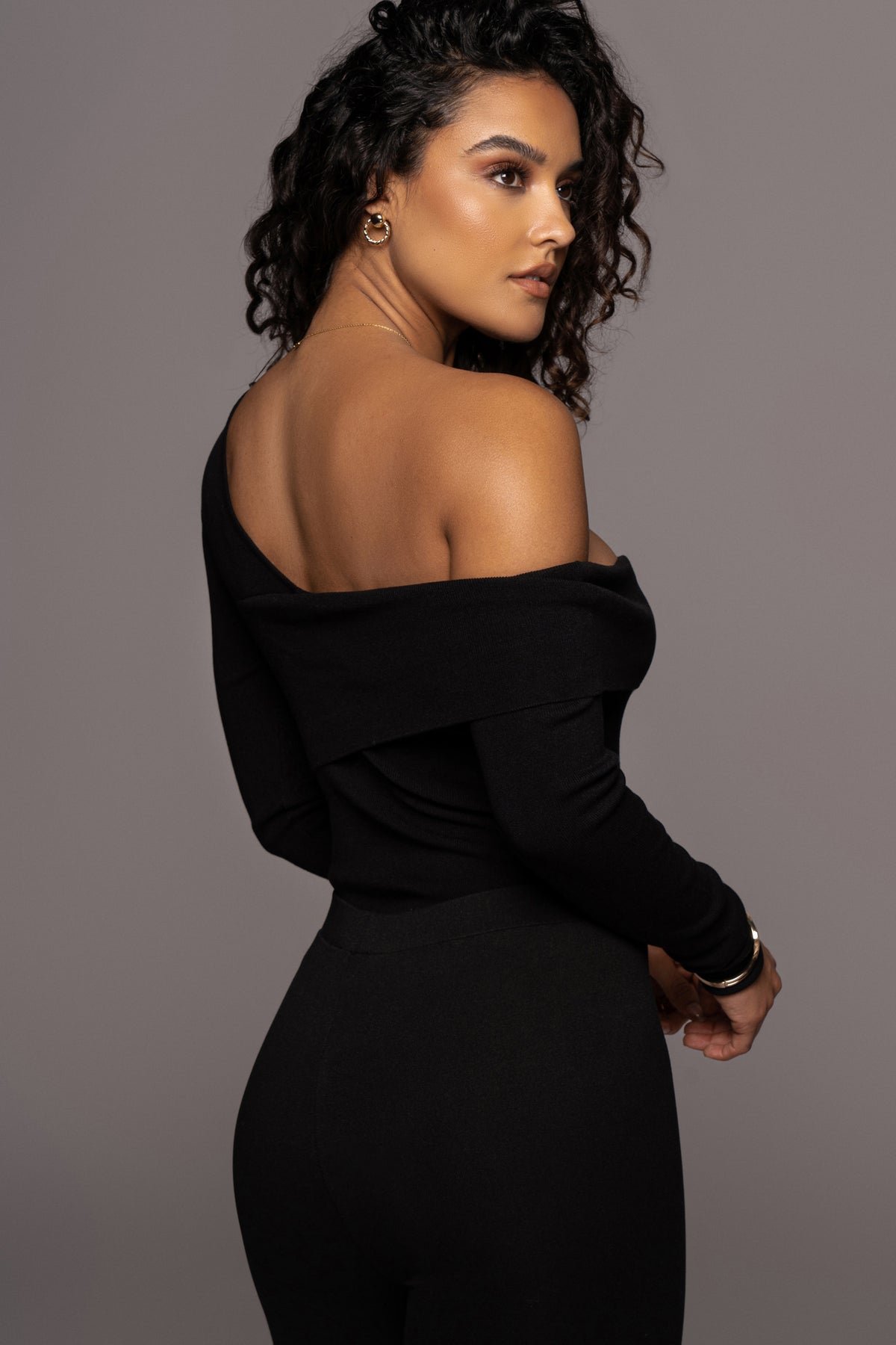 Black Eve off-the-shoulder top from JLUXLABEL, showcasing a stylish, fitted blouse with a neckline that drapes off the shoulders.