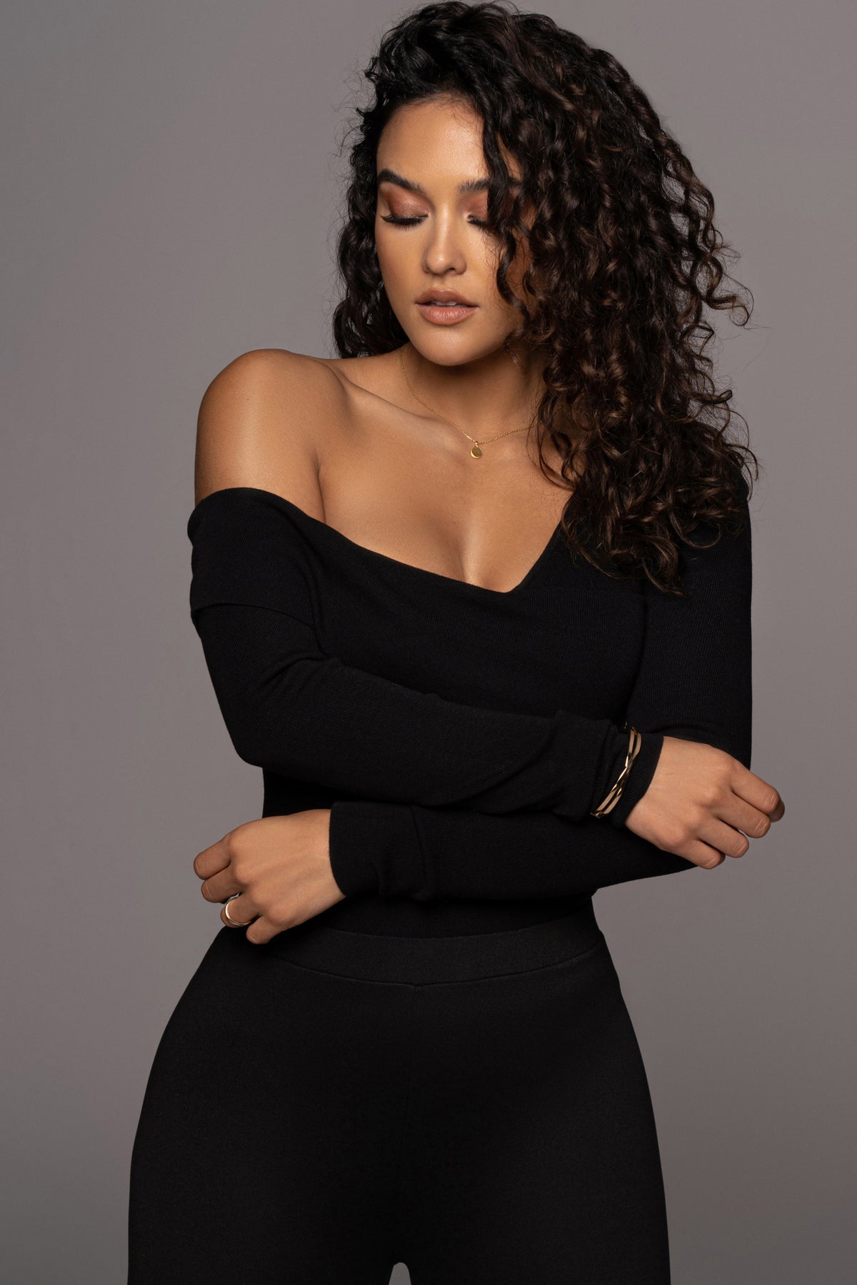 Black Eve off-the-shoulder top by JLUXLABEL, featuring a stylish neckline and fitted design, shown on a model.