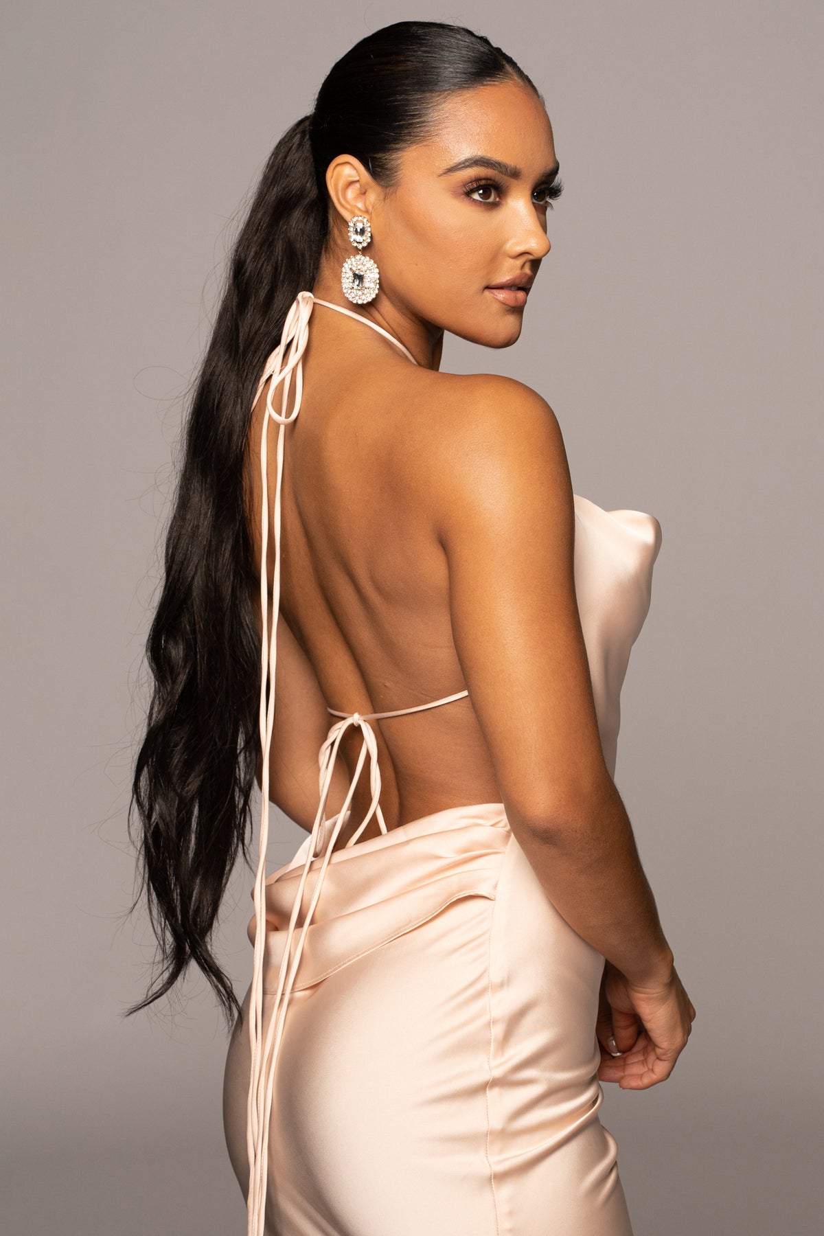 JLUXLABEL Champagne Irresistible Satin Maxi Dress displayed on a hanger, featuring a flowing satin fabric and elegant design.
