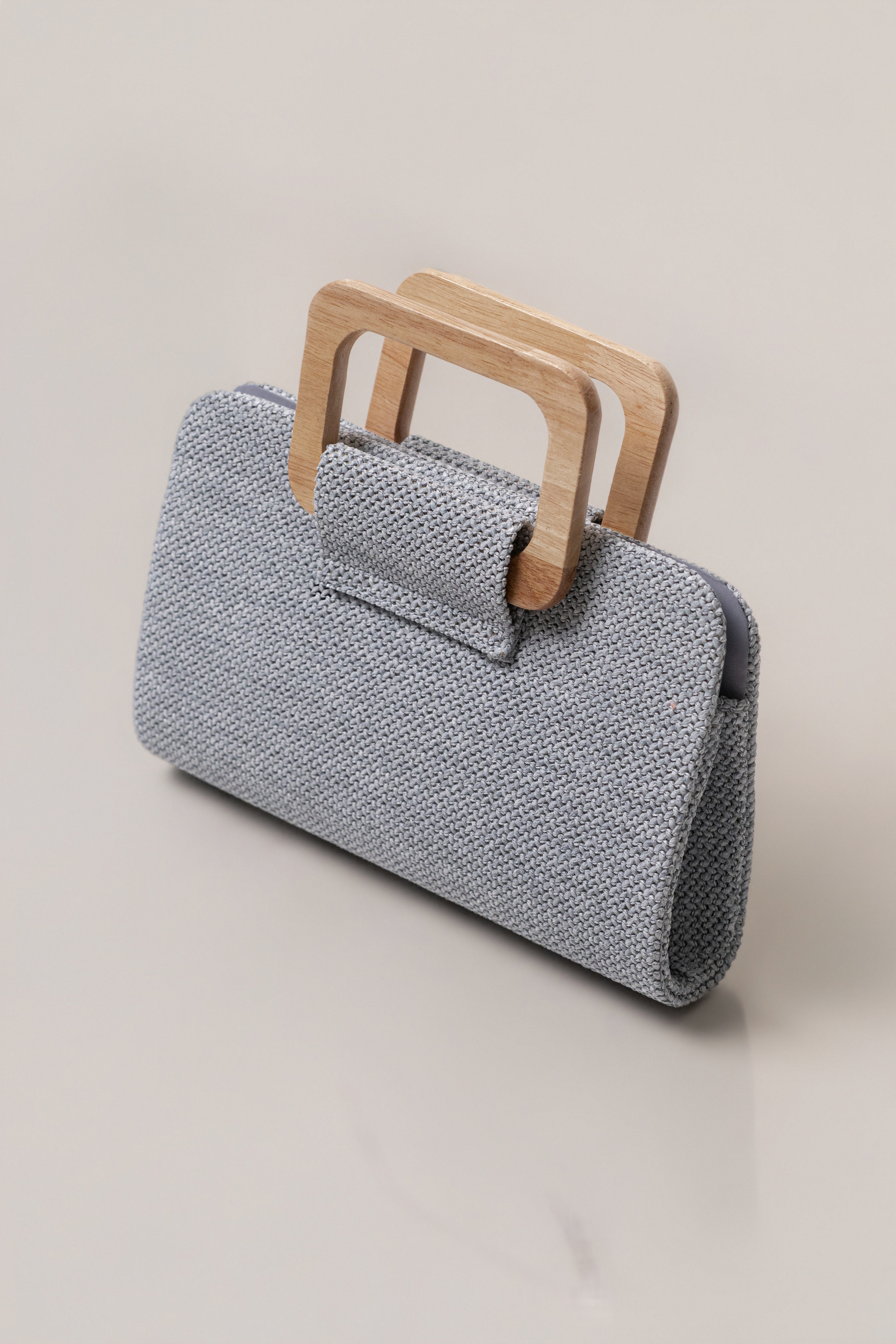 Blue Isola clutch bag by JLUXLABEL, stylish accessories with a sleek design, featuring a vibrant blue color and compact size.