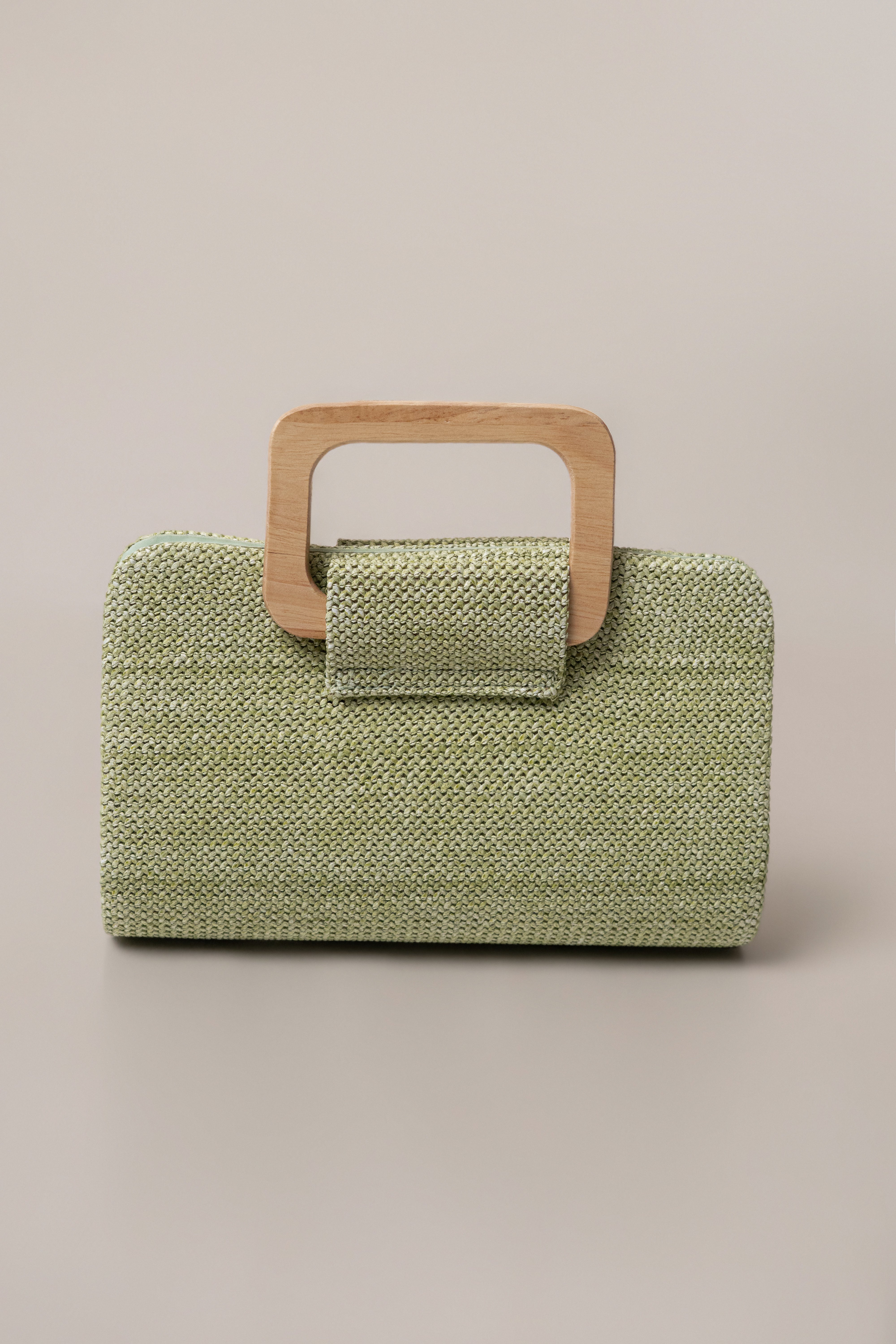 Sage Isola clutch bag by JLUXLABEL featuring a sleek design with a textured finish, perfect for accessories and evening outings.