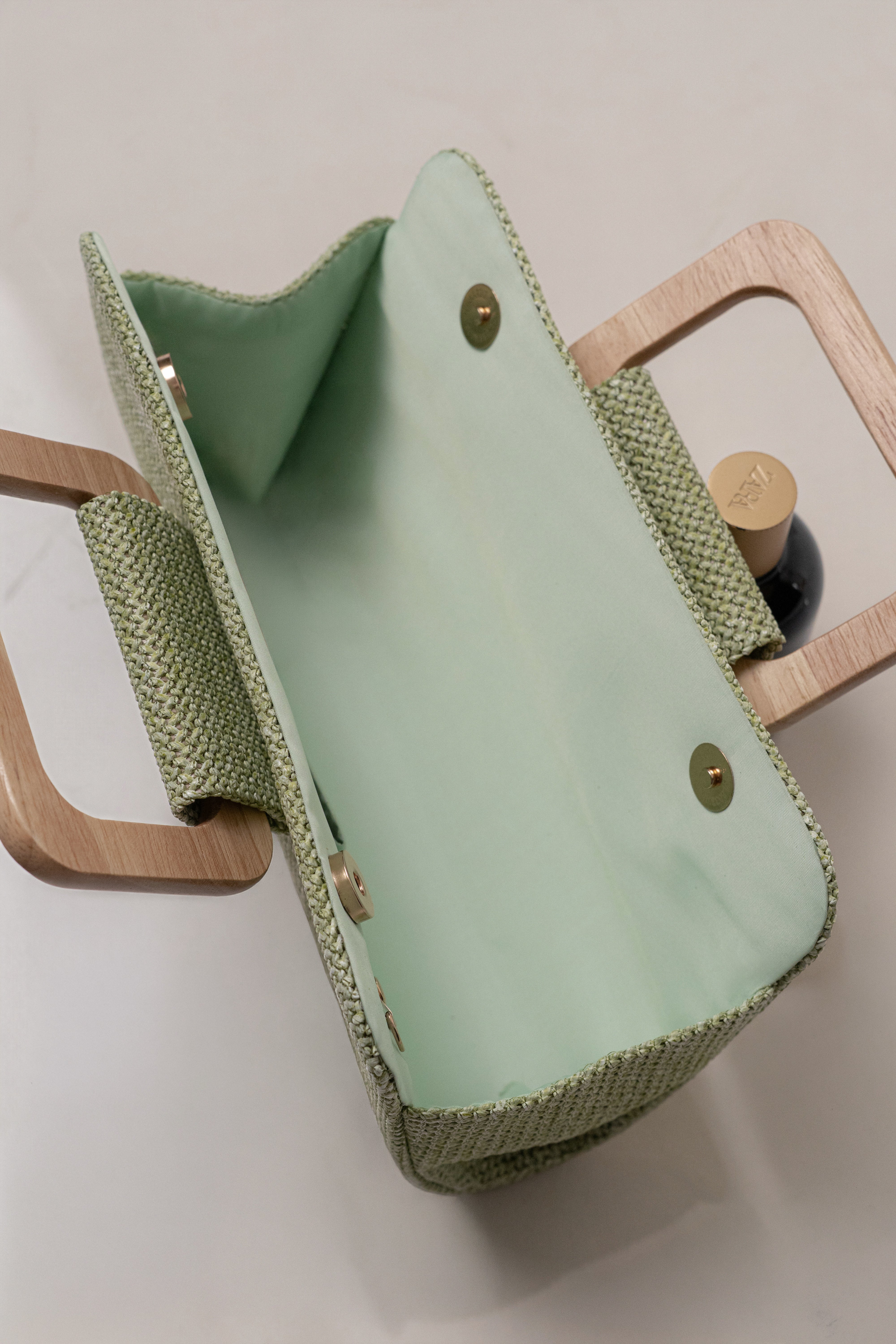 Sage Isola clutch by JLUXLABEL, stylish accessories with a sleek design, featuring elegant details and a compact shape.