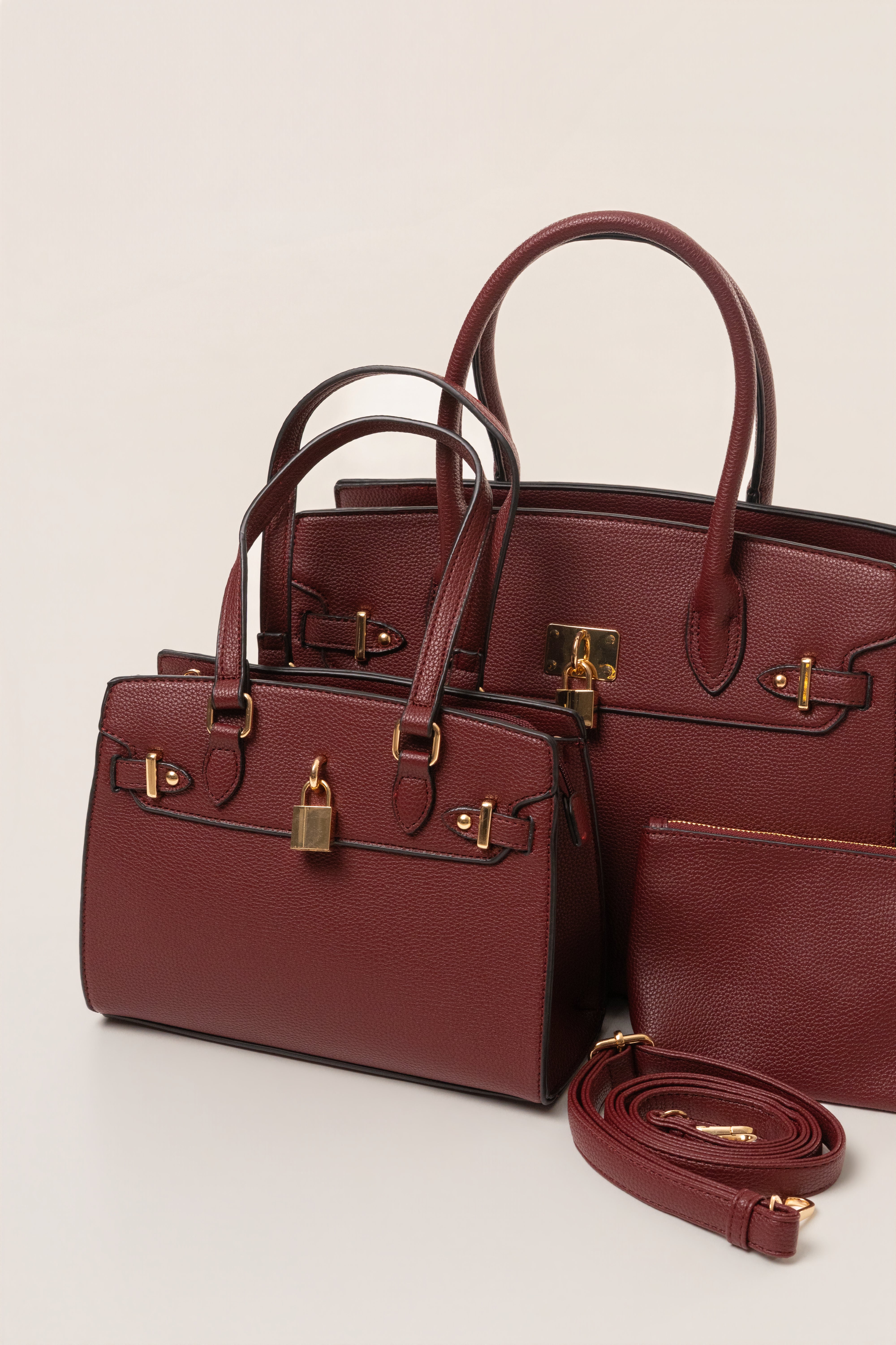 Burgundy JLUXLABEL Alva handbag made of smooth leather, featuring a sleek design and top handle for stylish accessories.