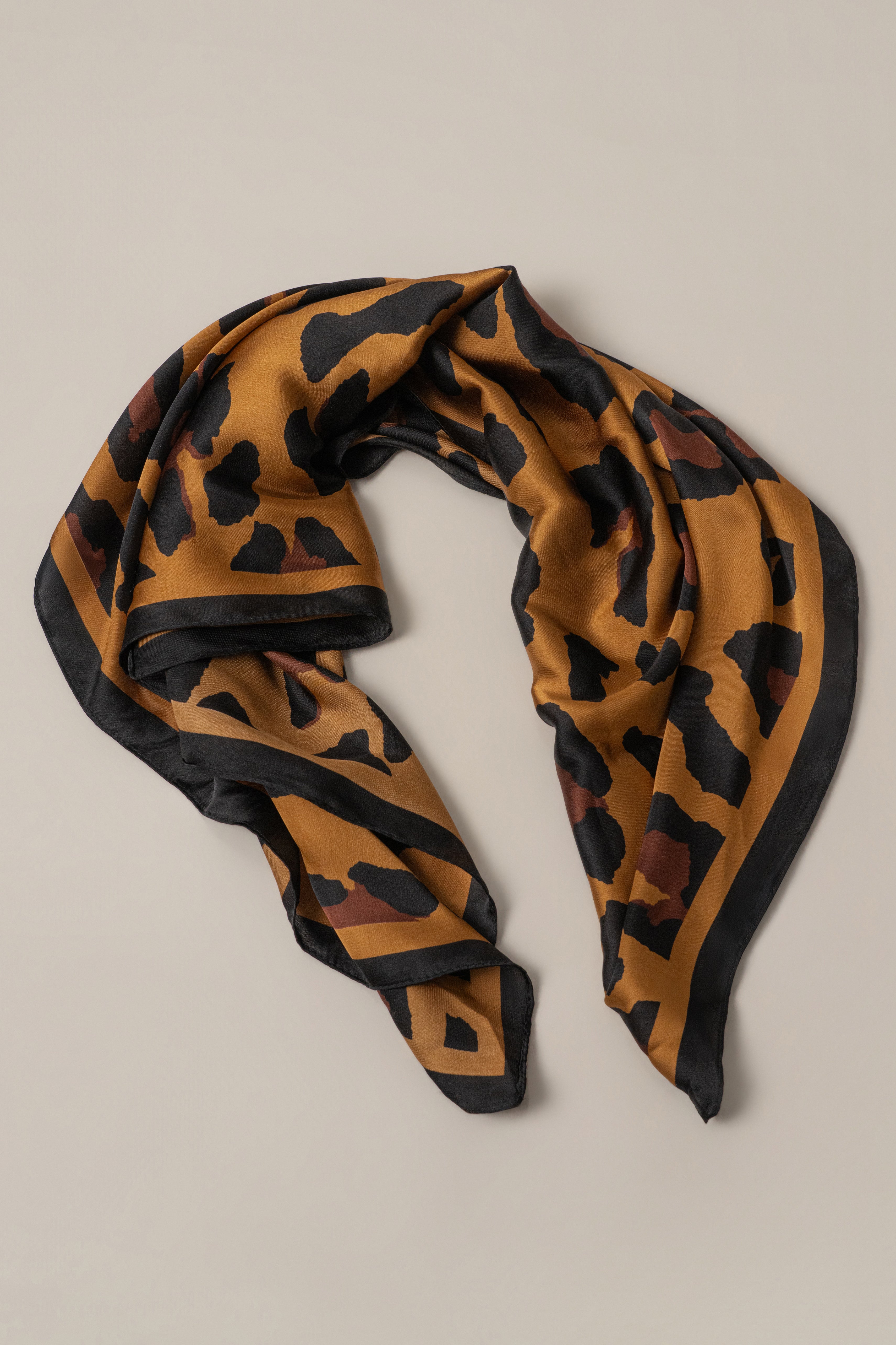 Brown Bold Nature scarf by JLUXLABEL, featuring a soft fabric and vibrant earthy tones, styled as a fashionable accessory.