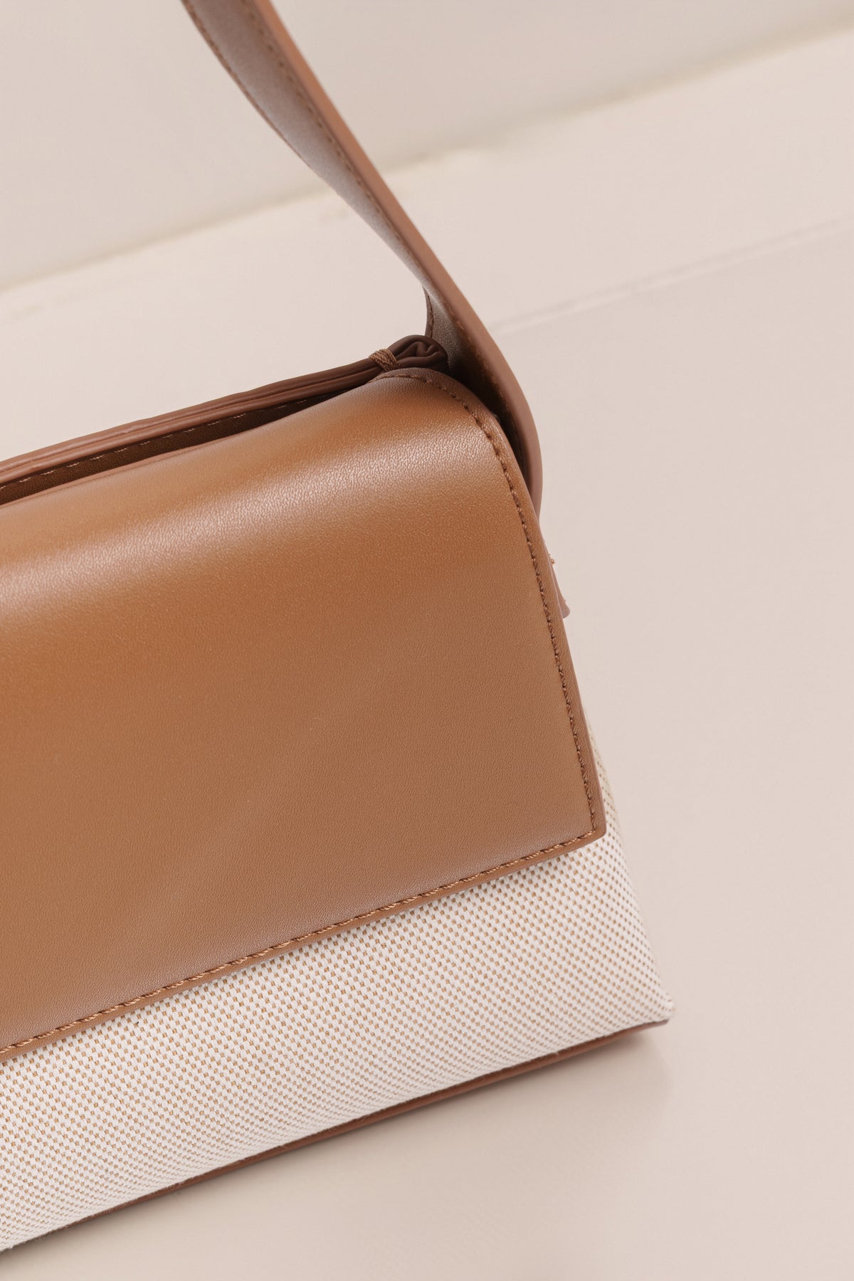 Beige JLUXLABEL Hudson shoulder bag with adjustable strap and silver hardware, stylish accessory for everyday use.