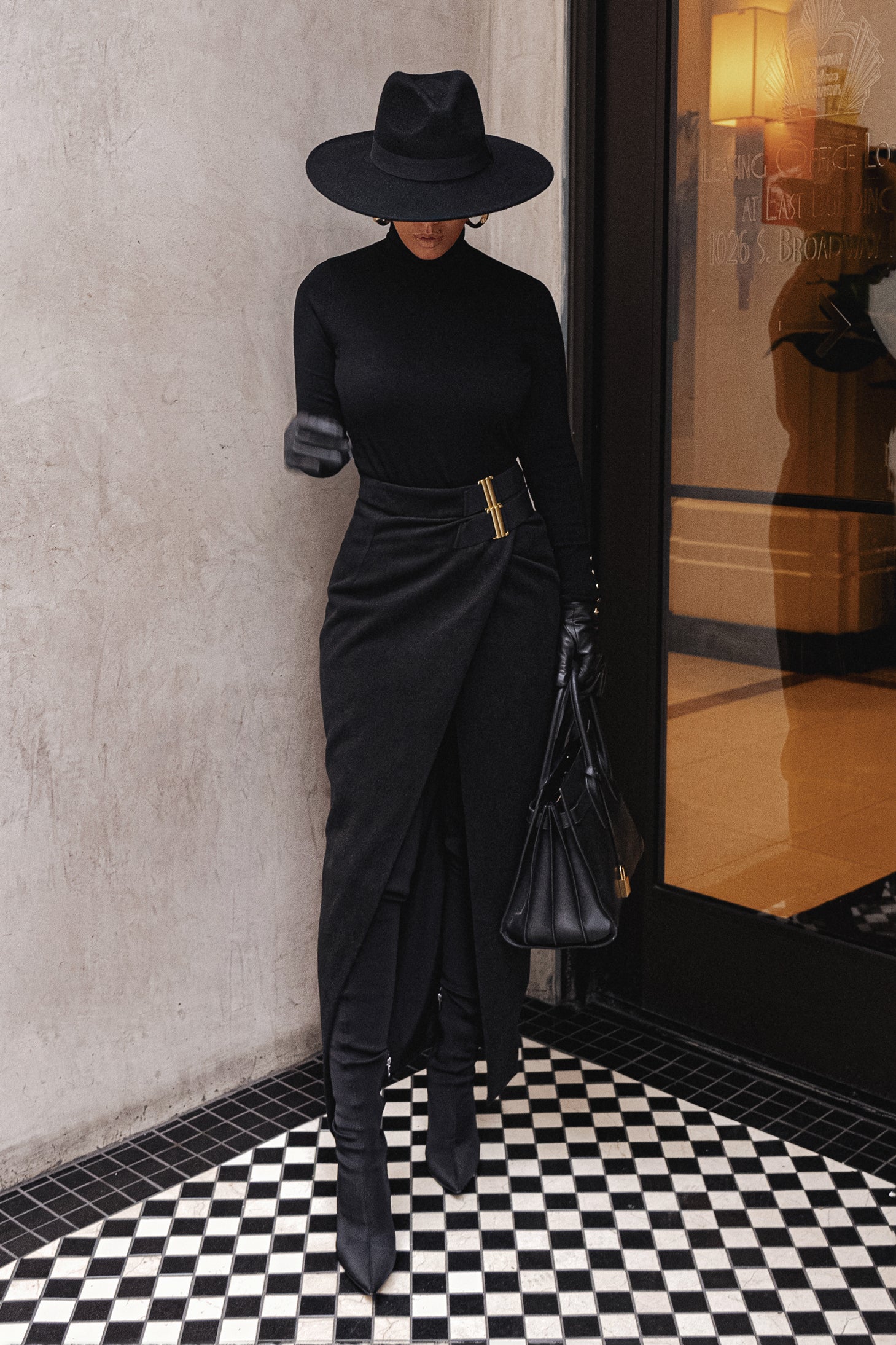 Black Gisele slit skirt from JLUXLABEL, styled as casual bottoms, featuring a sleek design with a high slit.