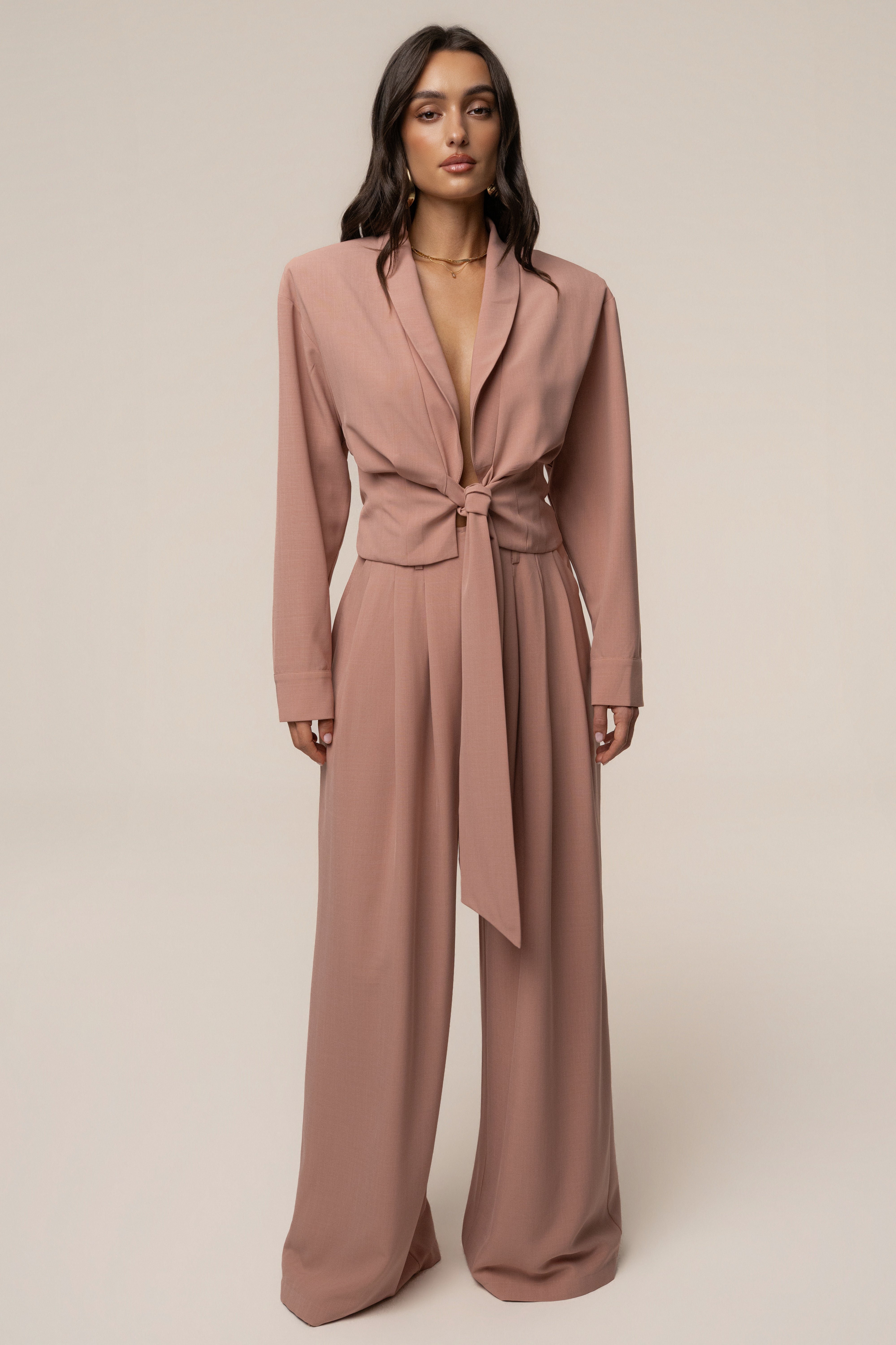 Mauve JLUXLABEL wrap top with long sleeves and V-neck, styled with a tied waist for a chic, casual look.