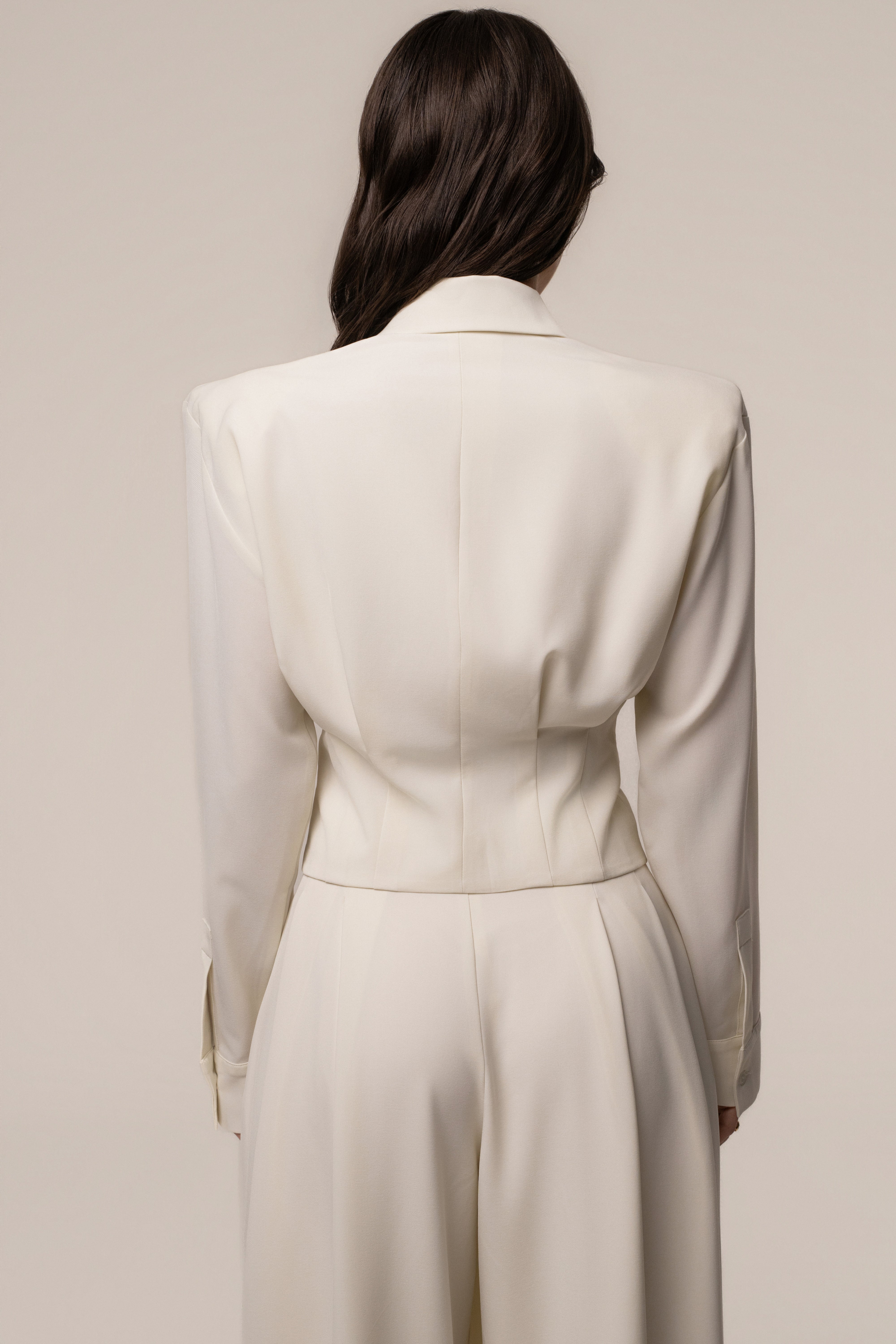 Cream JLUXLABEL Estate Wrap Top displayed on a hanger with soft fabric folds and stylish neckline detail.