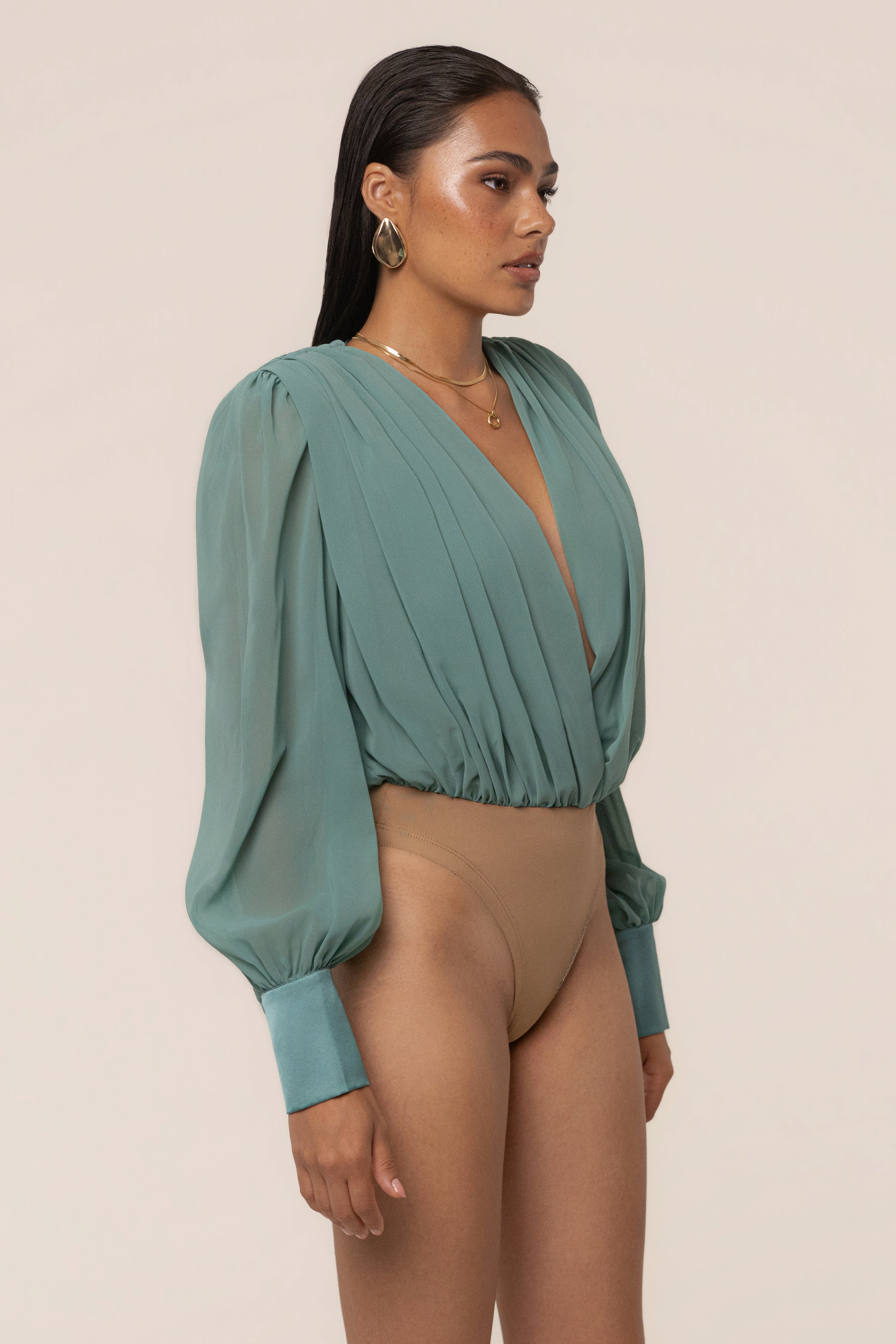 Teal JLUXLABEL pleated chiffon top with elegant design and flowing fabric, displayed on a hanger against a neutral background.