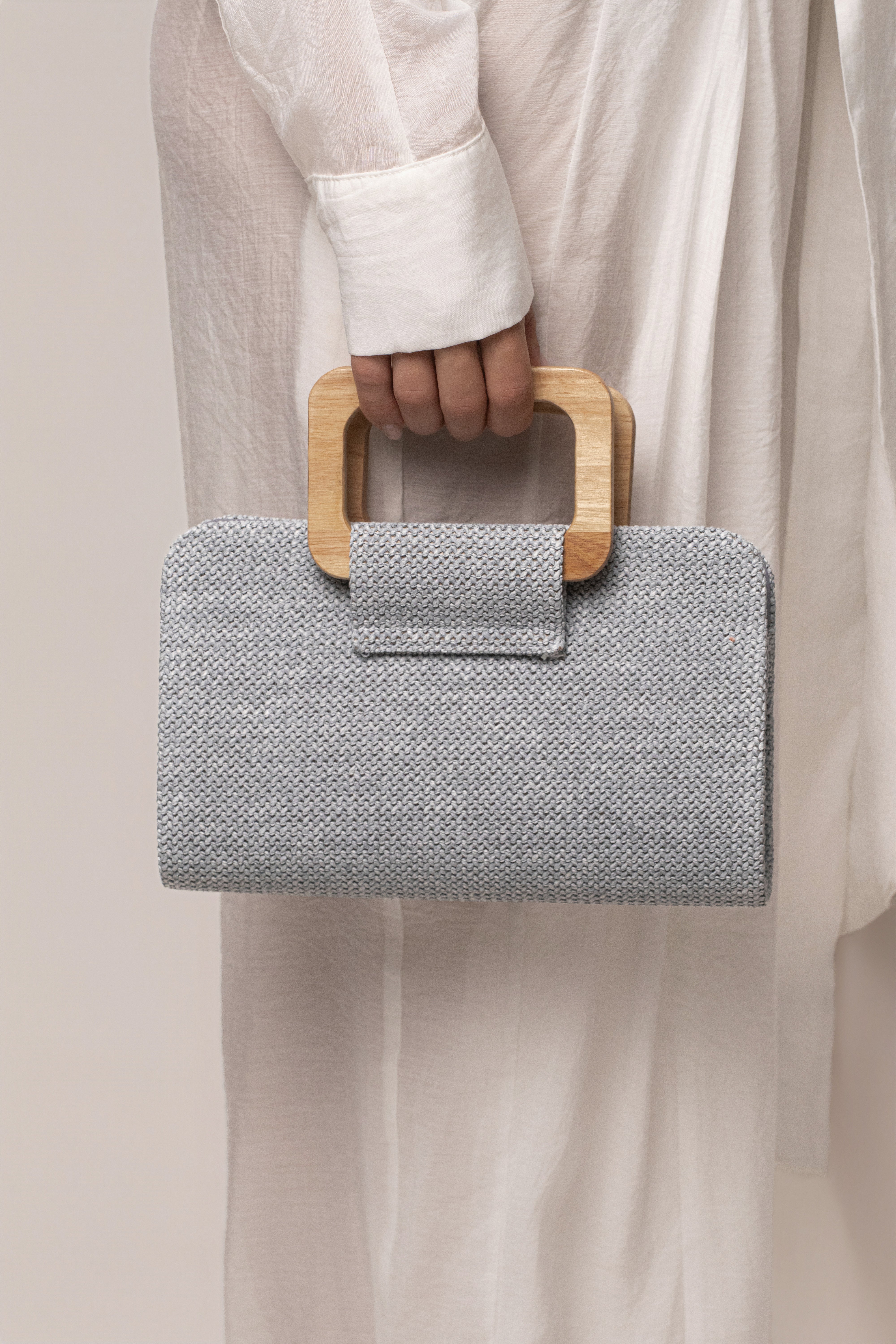 Blue Isola clutch bag by JLUXLABEL featuring a sleek design and compact size, perfect for accessories and evening outings.