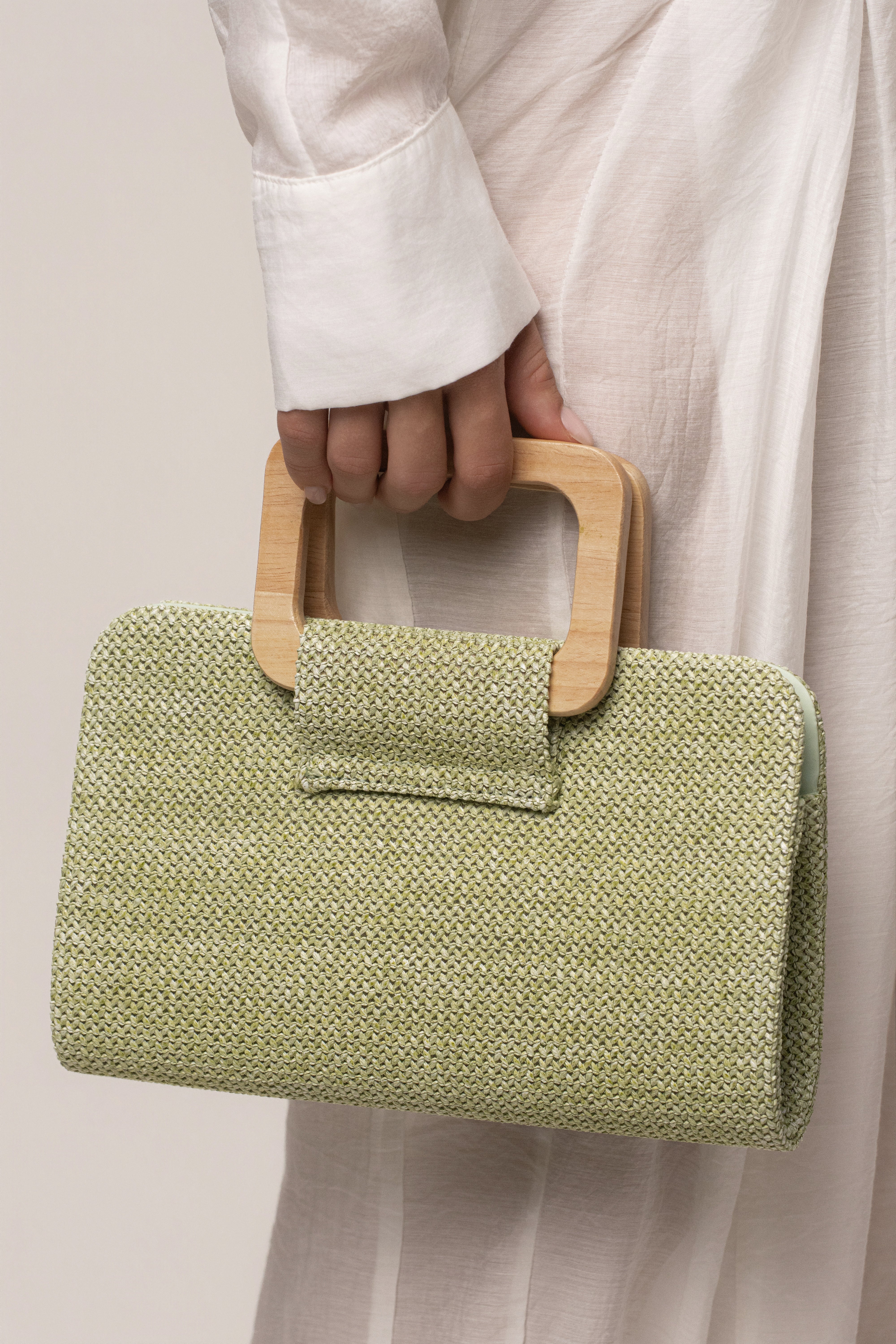 Sage Isola clutch by JLUXLABEL featuring a sleek design and compact size, perfect for accessories and evening outings.