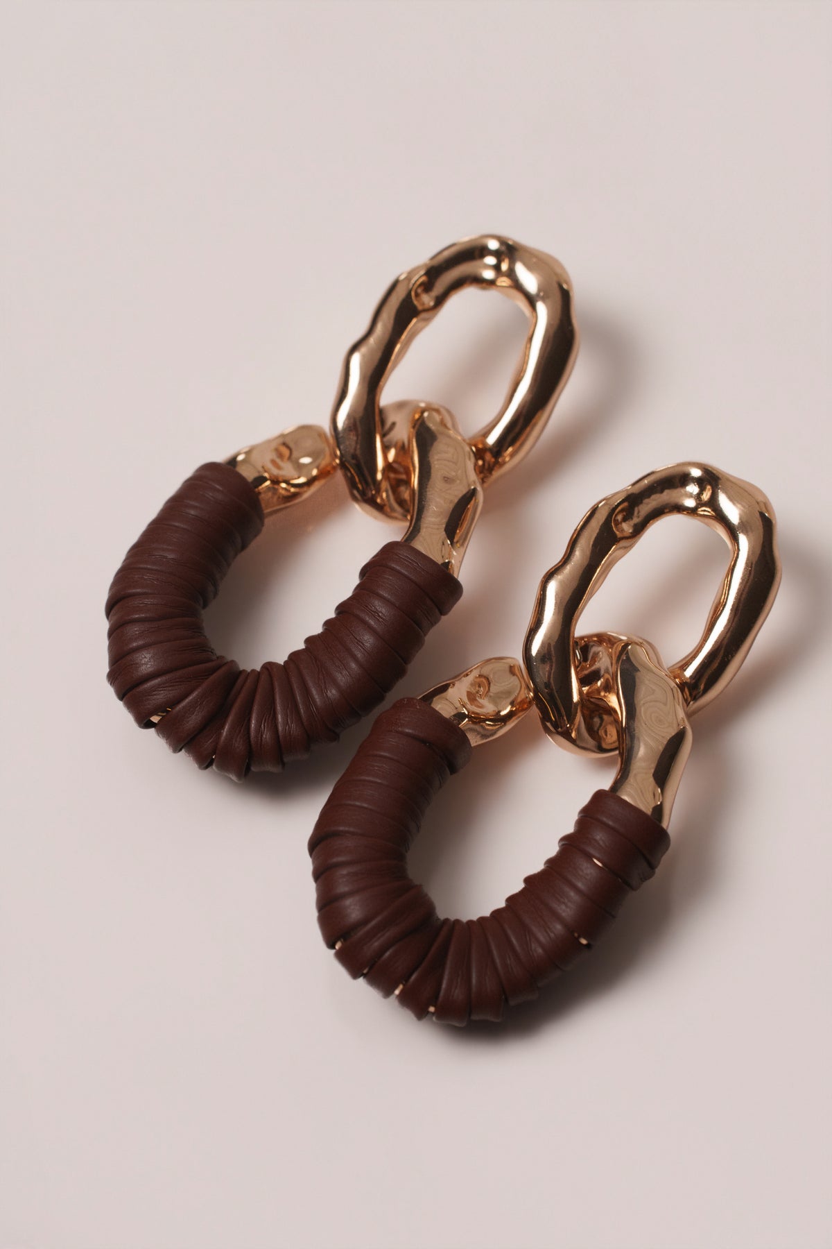 Brown Camille earrings by JLUXLABEL, stylish jewelry with gold accents and intricate design, displayed on a neutral background.