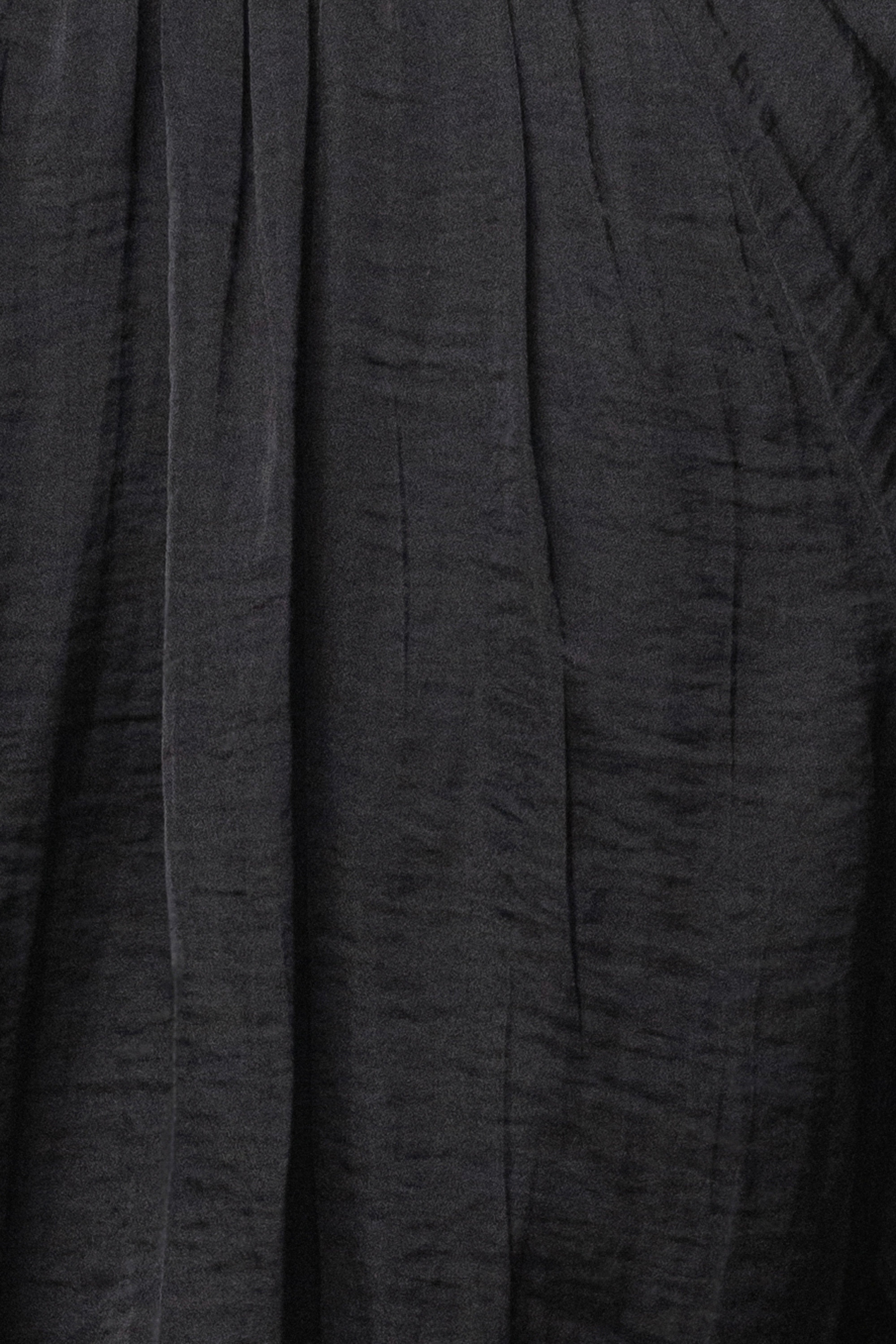 Black Seaside Glow Top by JLUXLABEL, showing lightweight fabric and off-shoulder design on a model.