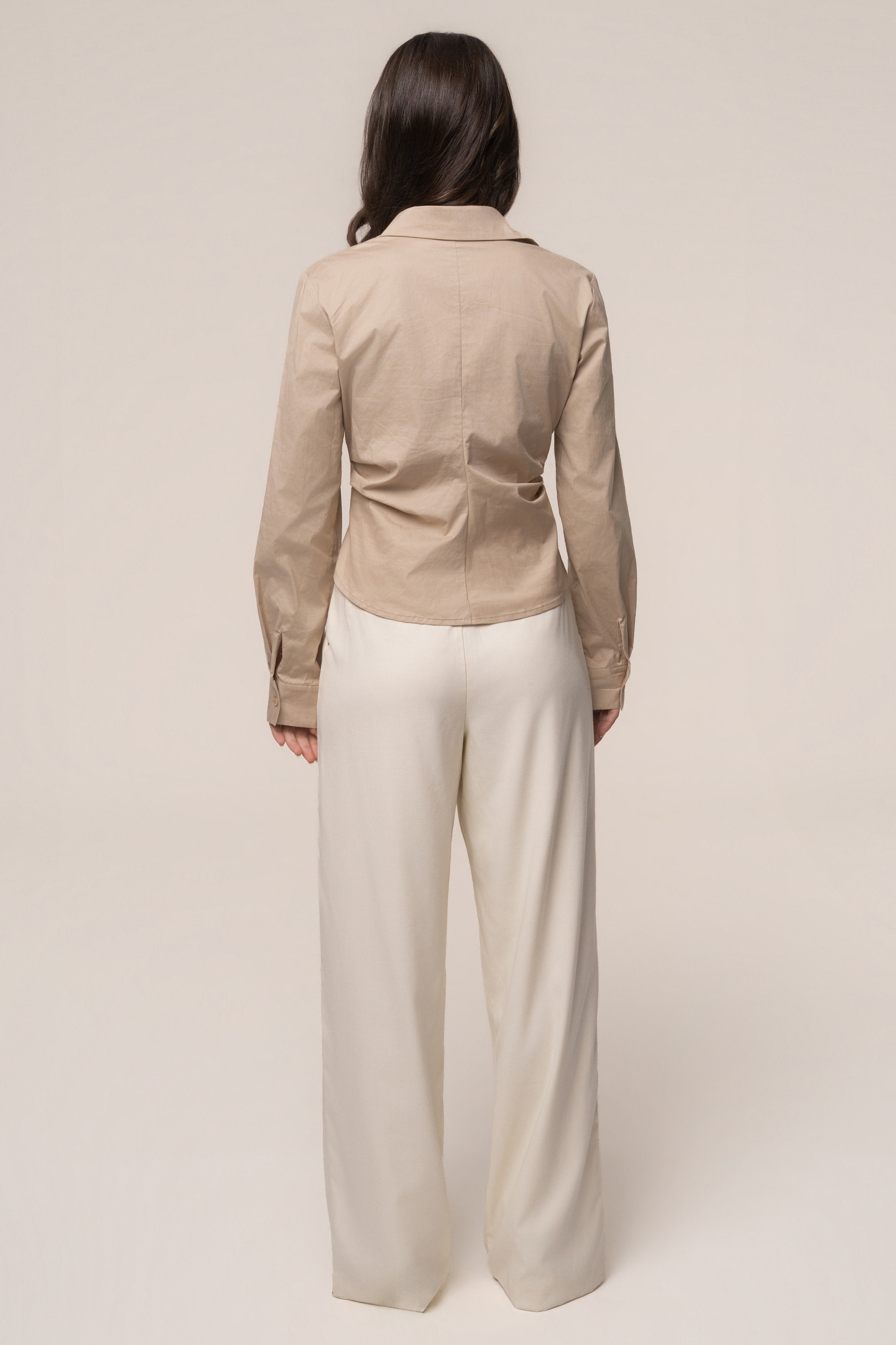 Beige Sculpt and Form blouse from JLUXLABEL, stylish tops with a fitted silhouette, displayed on a hanger.