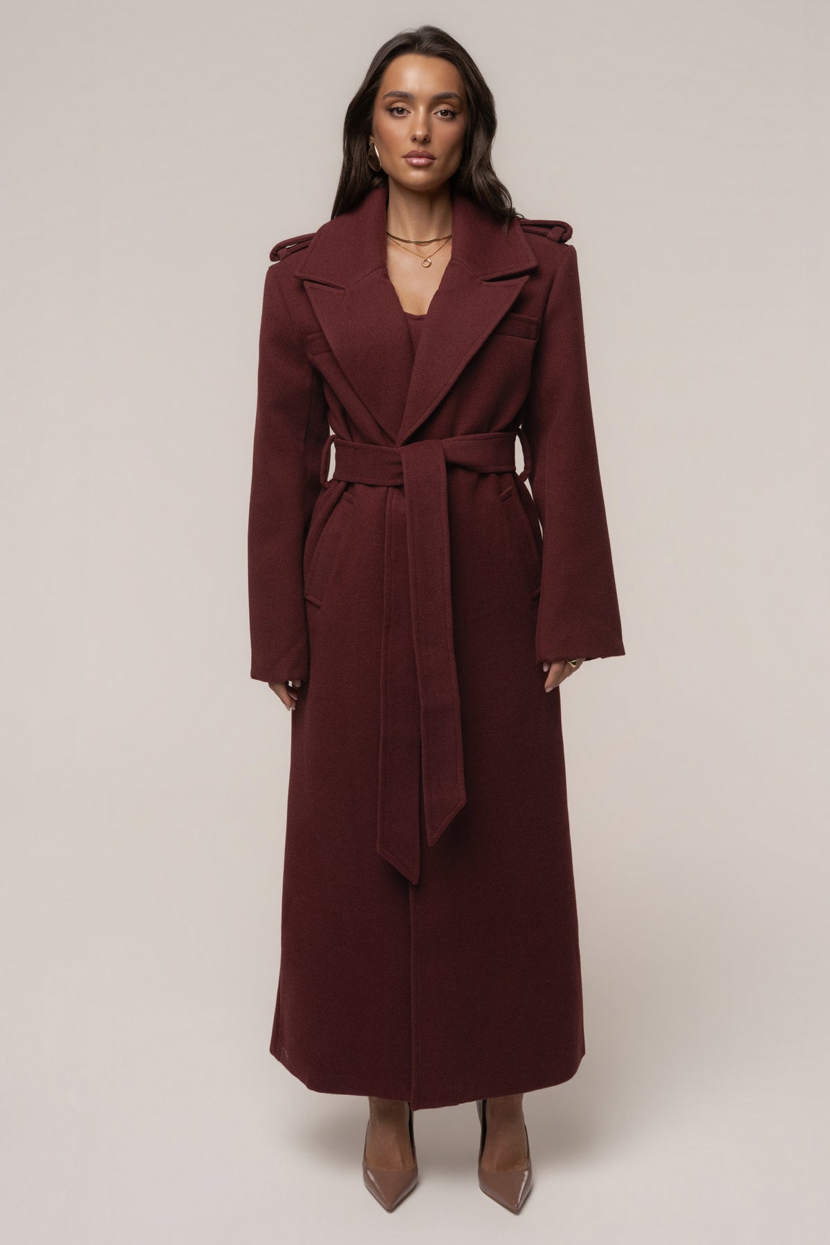Burgundy JLUXLABEL Savannah belted coat, stylish outerwear with a fitted silhouette and collar, displayed on a hanger.
