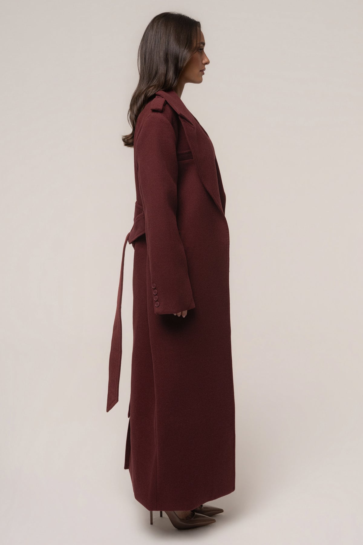 Burgundy Savannah belted coat by JLUXLABEL, stylish outerwear with a tailored fit and belt detail, displayed on a hanger.