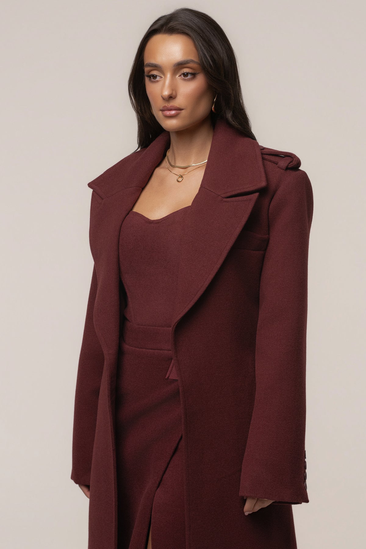 Burgundy JLUXLABEL Savannah belted coat, stylish outerwear with a tailored fit and button closure, shown on a model.