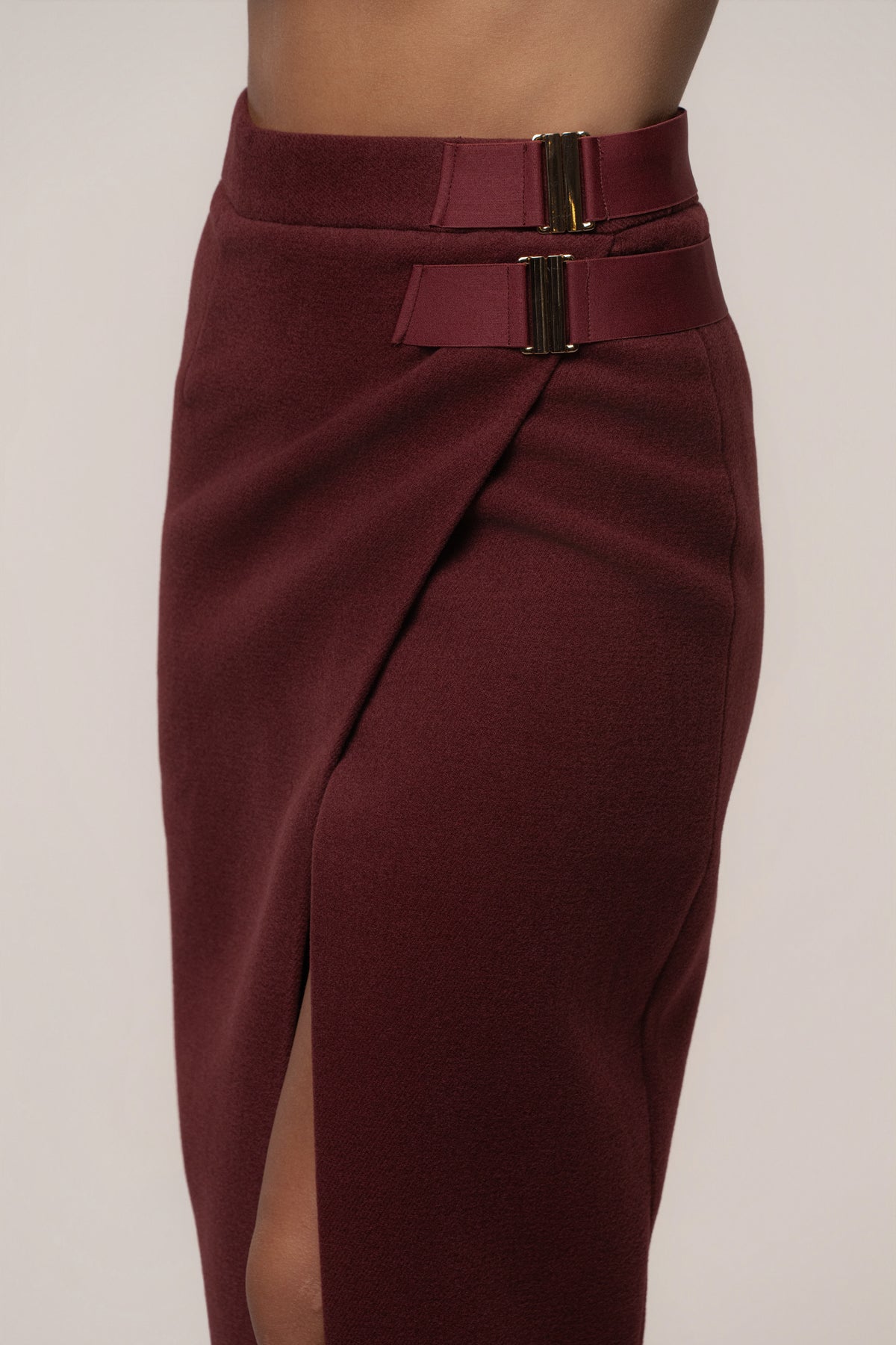 Burgundy Gisele slit skirt from JLUXLABEL, stylish bottoms with a high slit, shown on a mannequin.