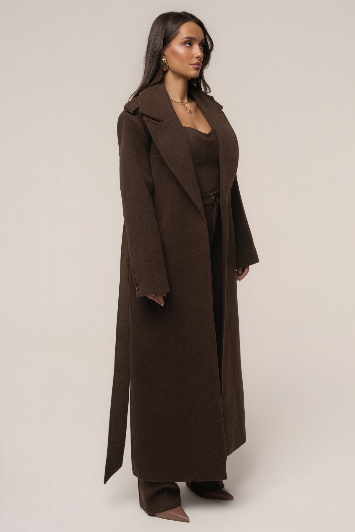 JLUXLABEL Chocolate Savannah belted coat, stylish outerwear with a tailored fit and button details, shown on a model.